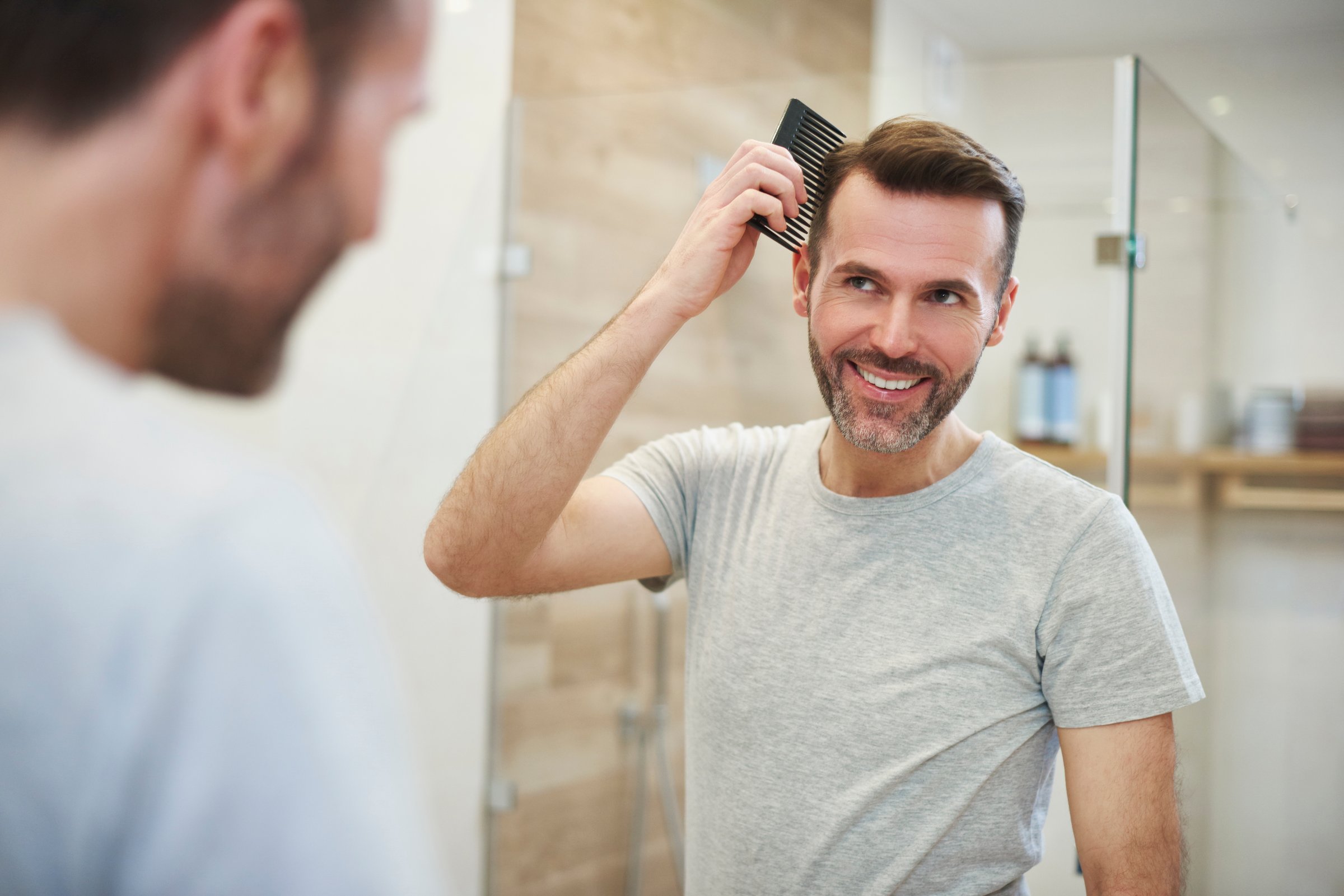 Man combing his hair in the bathroom