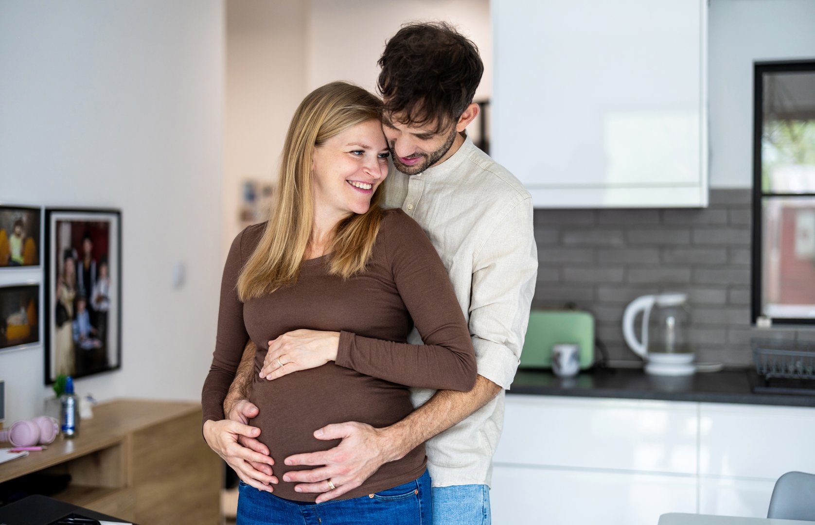 Portrait of a loving couple together at home expecting a baby