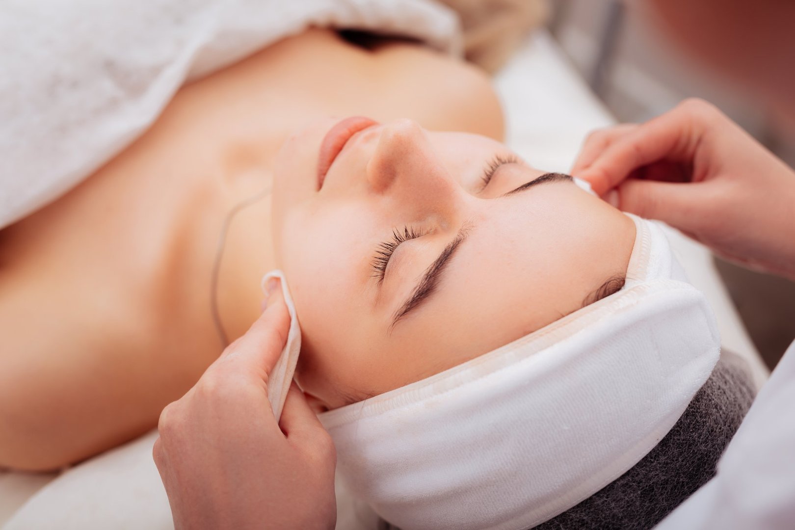 Caring about skin. Nice good looking woman visiting a cosmetology clinic while caring about her skin