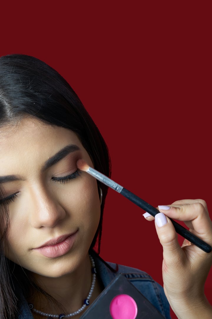 Make up artist doing professional make up of beautiful young woman.