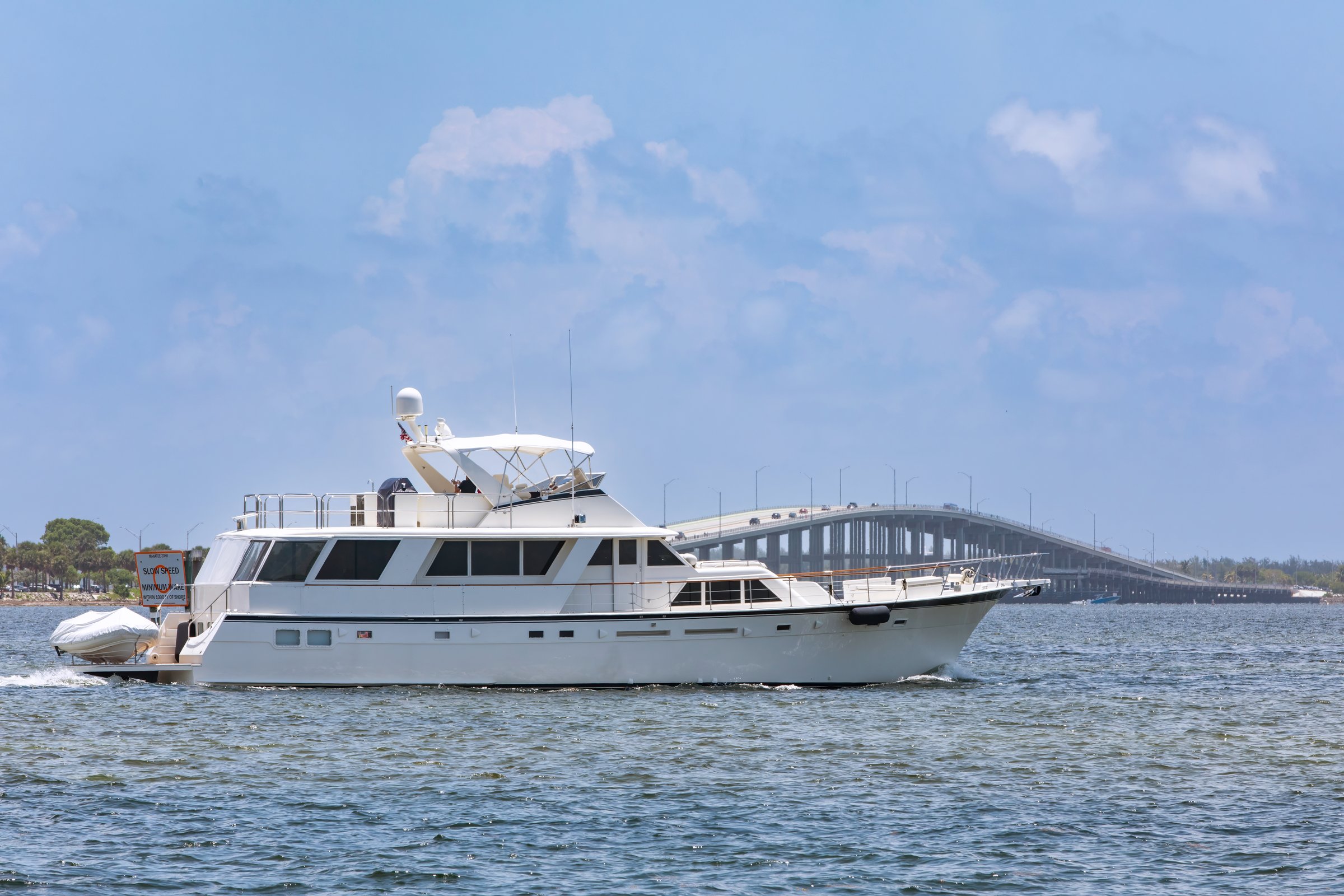 Motor yacht in bay in front of bridge