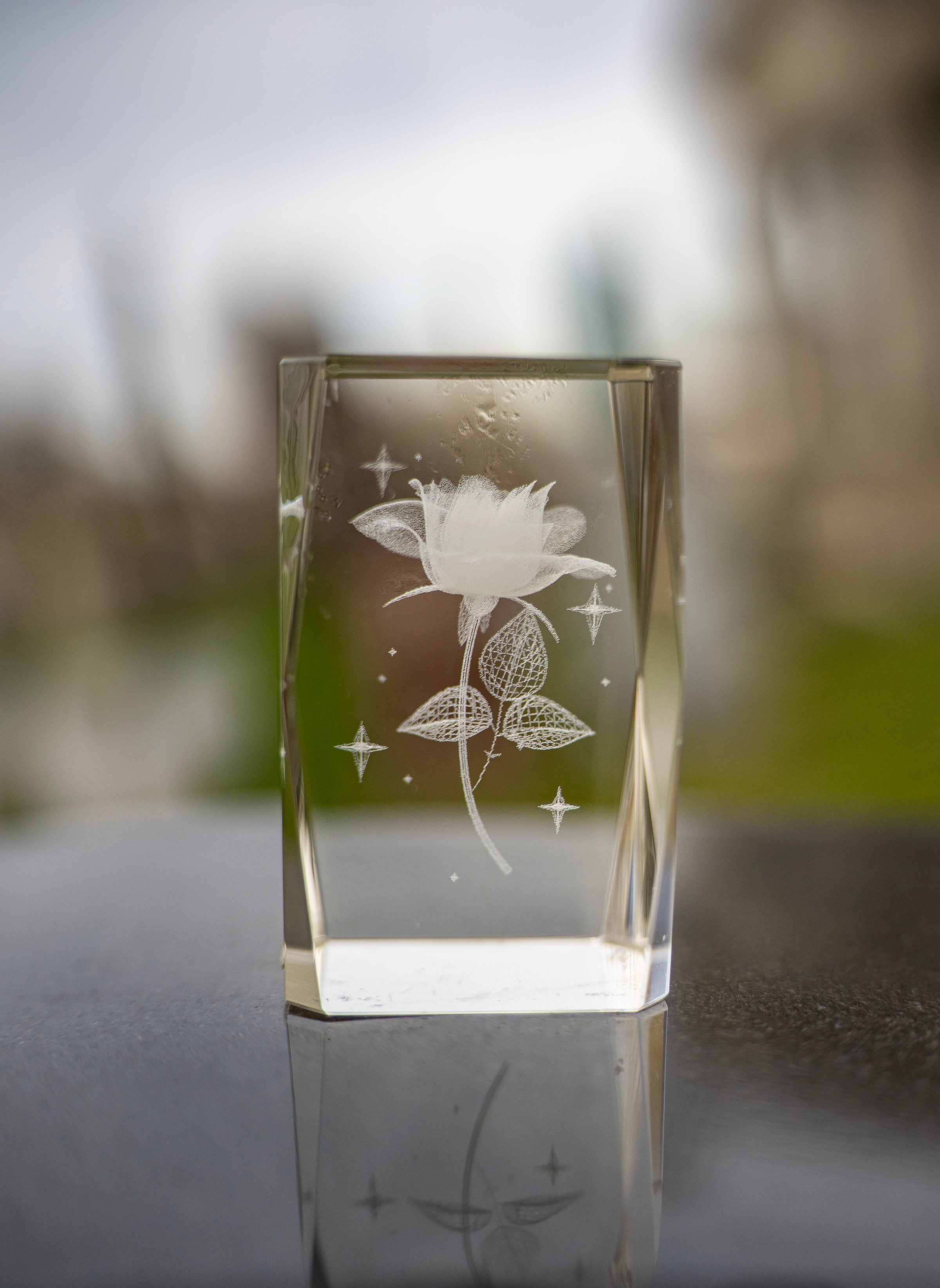 Laser Etched Crystal Cube dark foreground with shallow depth of field