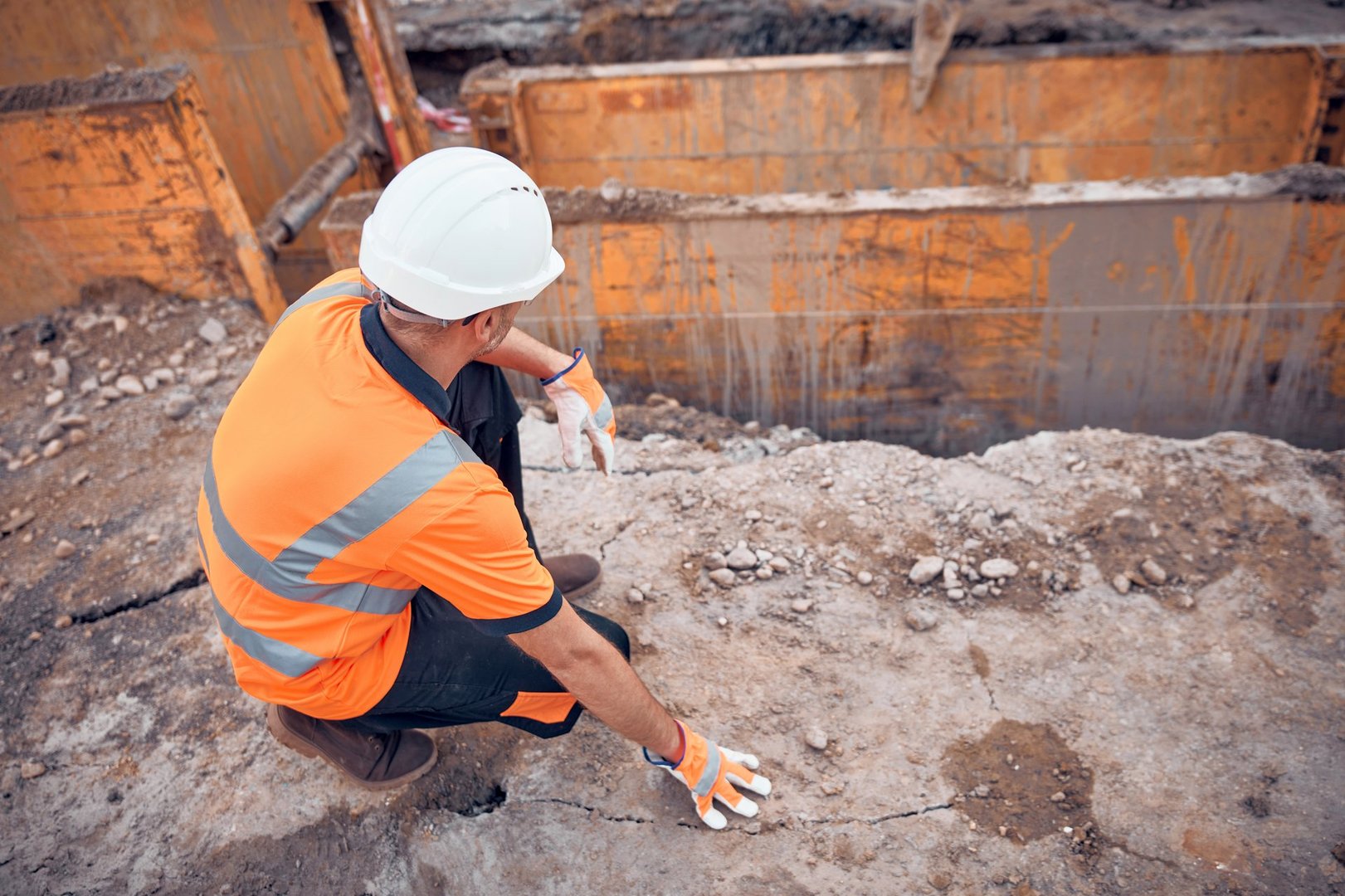 Construction worker working on a public city road reconstruction.