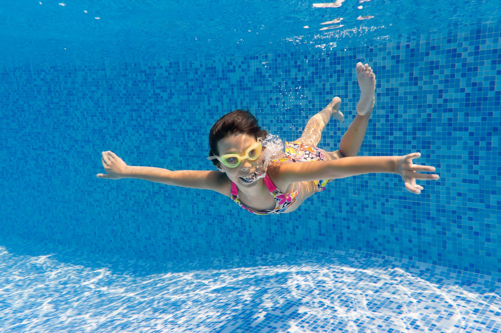Beautiful girl swim underwater in pool