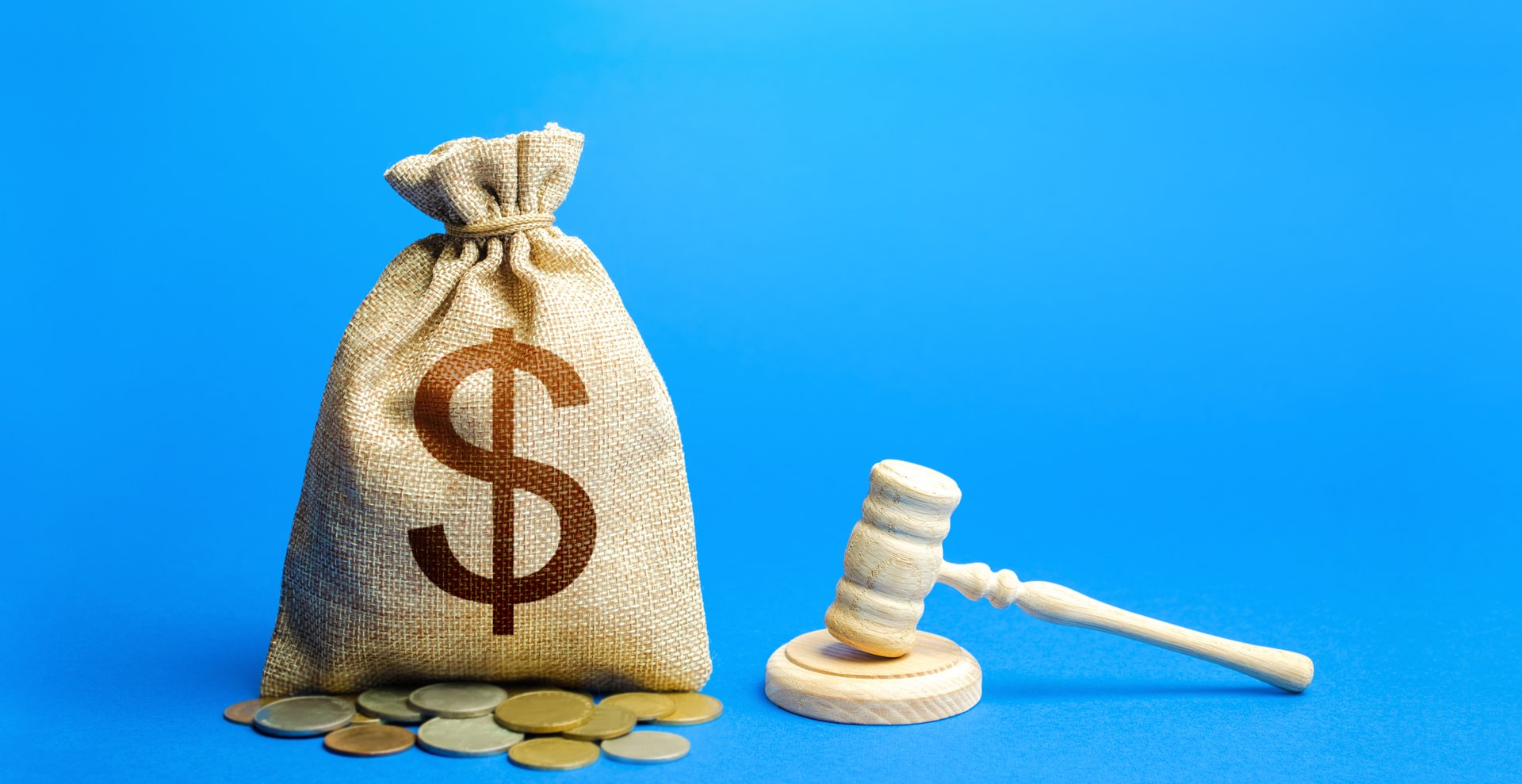 Dollar money bag and judge's gavel. Litigation, dispute resolution, conflict of interest settlement. Awarding moral financial compensation. Justice, rule of law. Lawyer services. Protection of rights