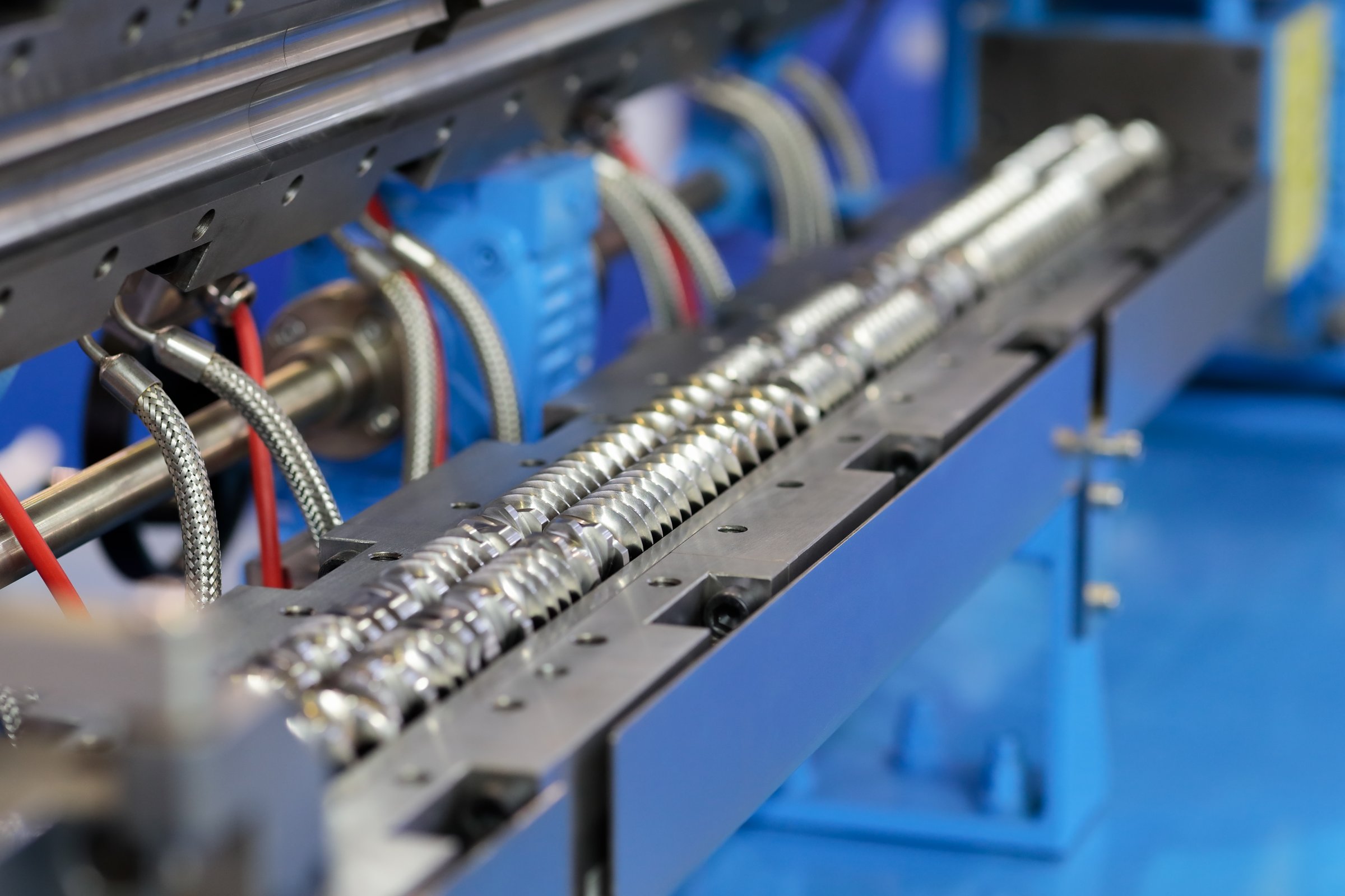 Twin screw plastic extruder machine close up. Selective focus.