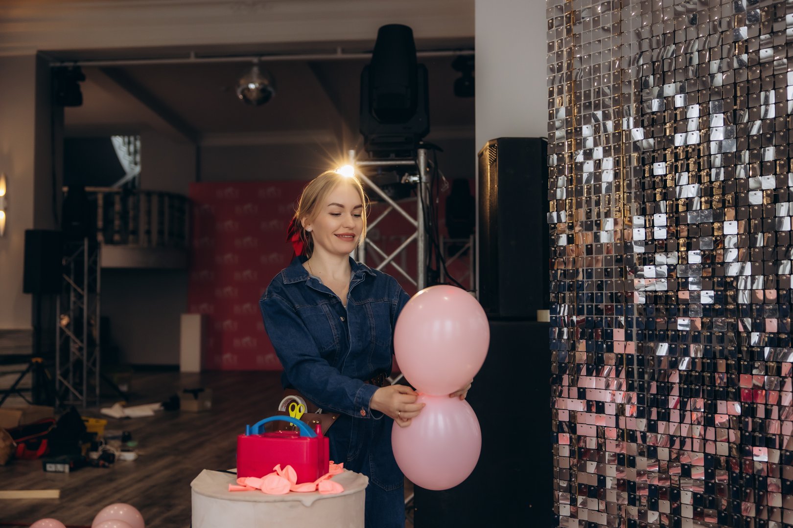 Woman arranging balloons for event celebration