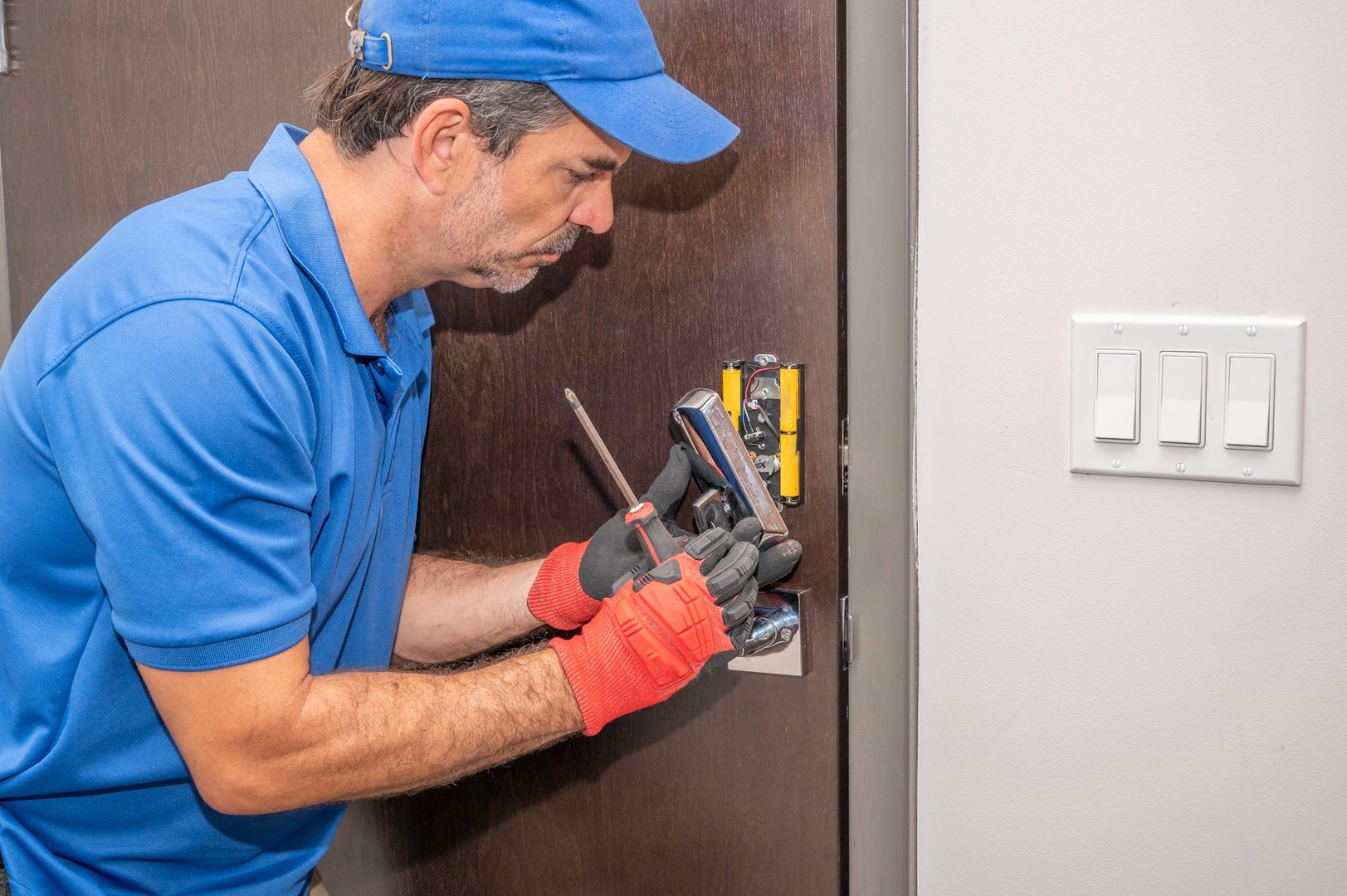 Locksmith disassembling a modern deadbolt lock
