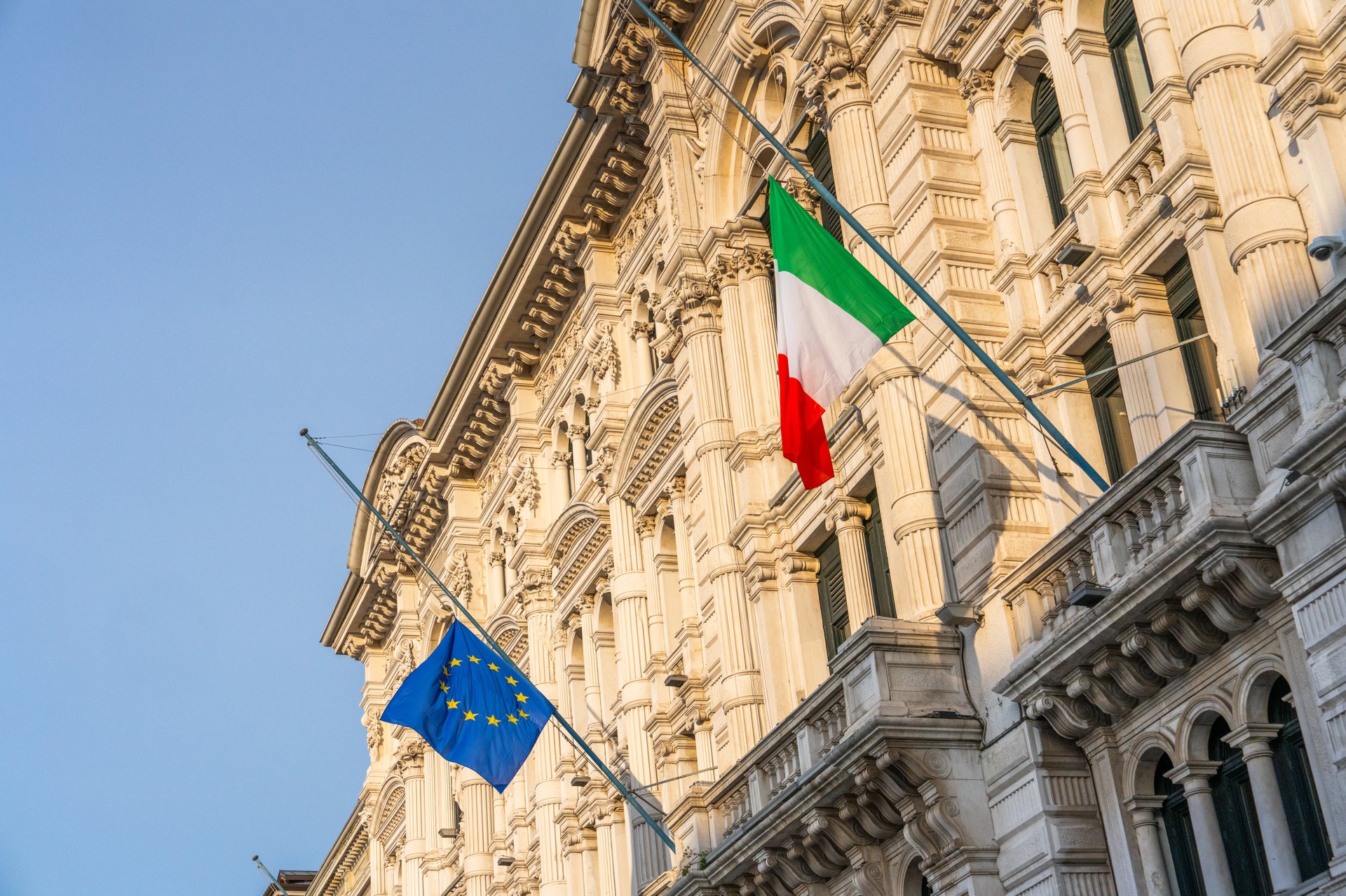 EU and Italian flag on a old government building in Triest, Italy