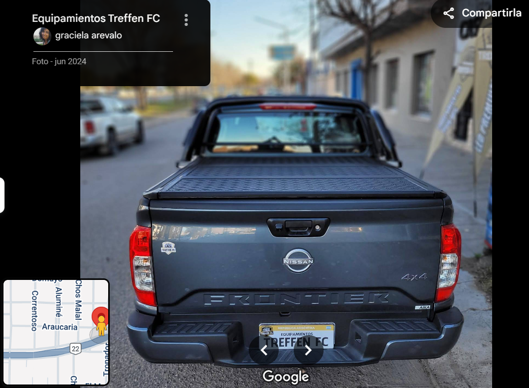 Rear view of a gray Nissan Frontier 4x4 truck parked on a street, visible license plate reads Treffen FC.