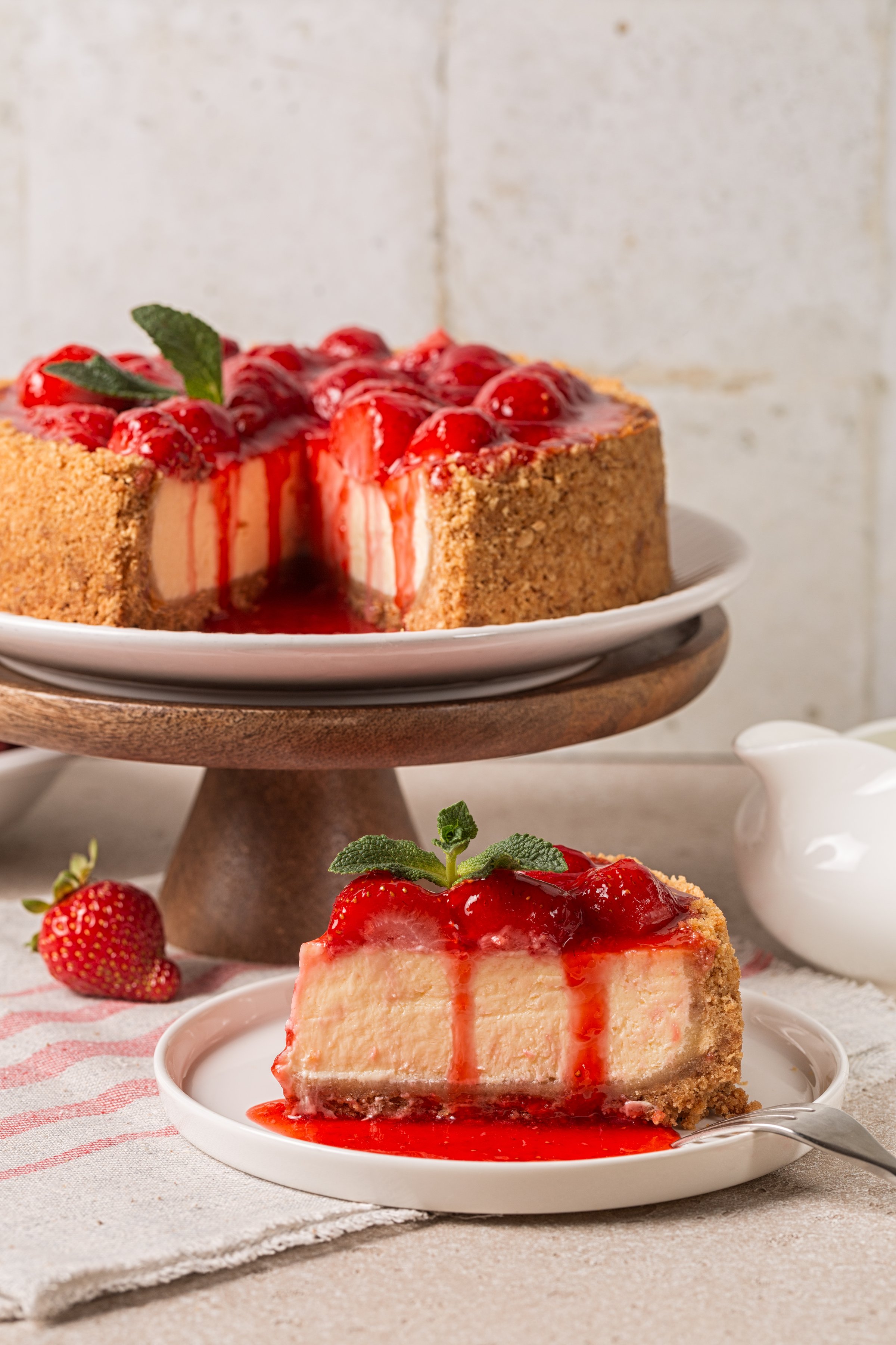 Piece of Classic baked Cheesecake  with a strawberry topping sauce. Homemade dessert. Vertical image.