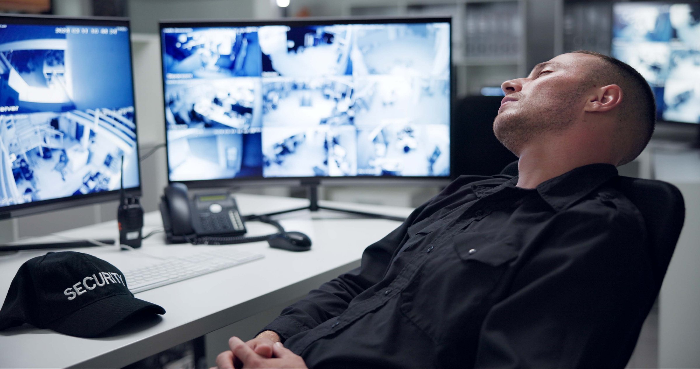 Security guard, computer screen and tired by cctv monitor for protection, data center or building safety. Inspection, control room with footage and video surveillance agency, technology and sleeping