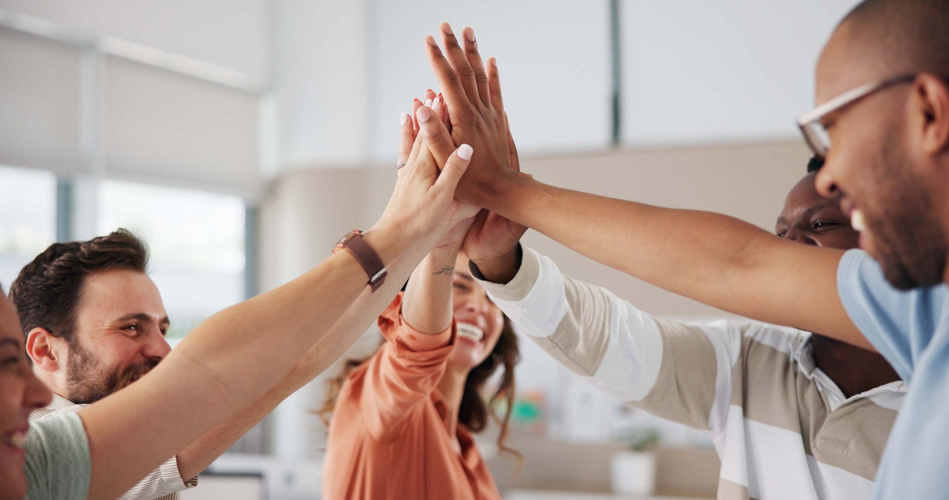 Office, business people and motivation with high five for team building, celebrate and support for startup. Cooperation, employees and designers with hands for deal, solidarity and success for goals