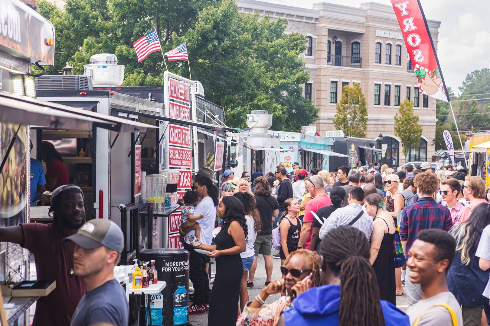 Suwanee, GA / USA - September 18, 2022:  A crowd of people wait in line at food trucks at Suwanee Fest, a fall festival on September 18, 2022 in Suwanee, GA.