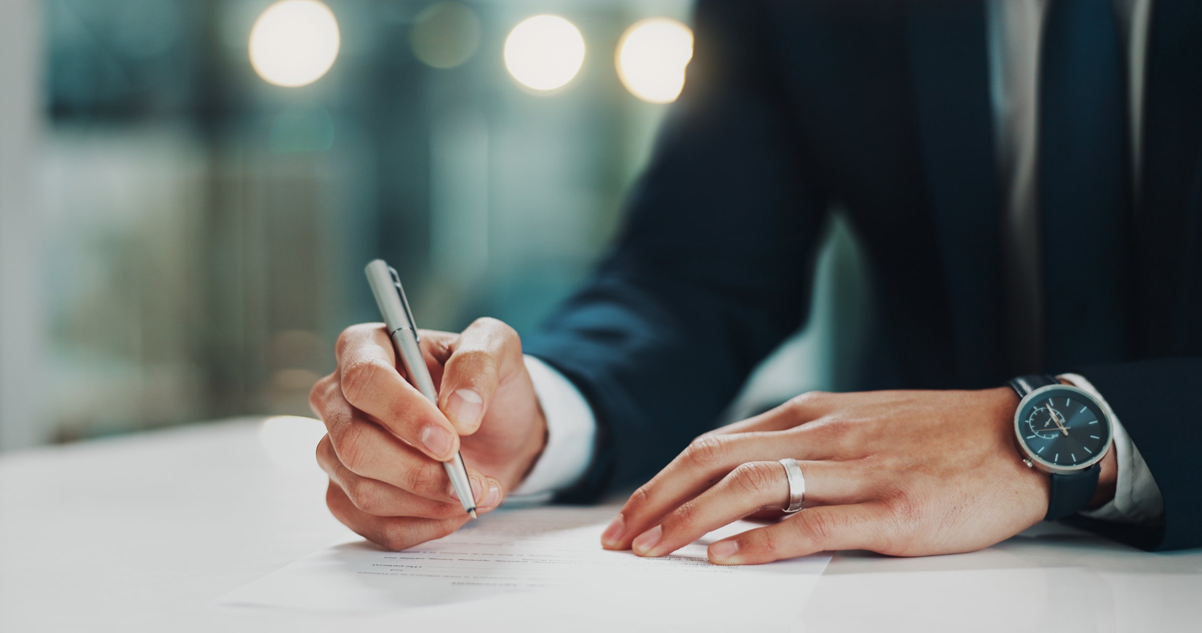 Hands, document and businessman with pen for signature in office for finance agreement, deal or application. Hiring, paperwork and candidate writing for filling in recruitment contract for onboarding