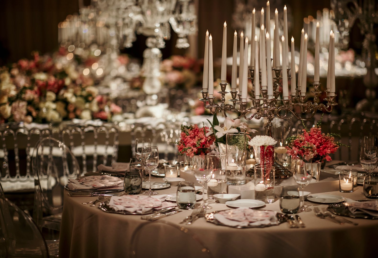Beautiful table setting for family Christmas dinner. Cozy atmosphere, candlelight on tall candelabras. stock photo