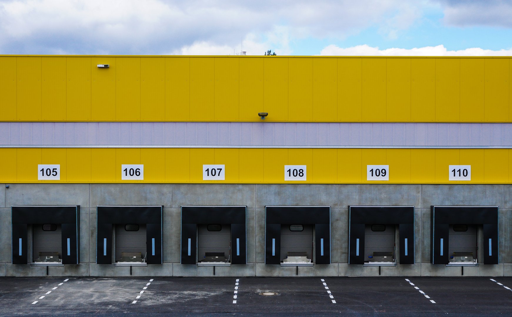Loading docks numbered 105 to 110 on a large industrial building