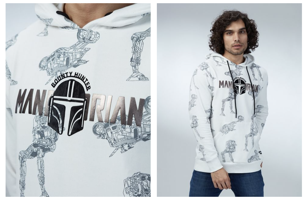White hoodie with Mandalorian design, featuring the helmet logo and bounty hunter text. Model wearing the hoodie.