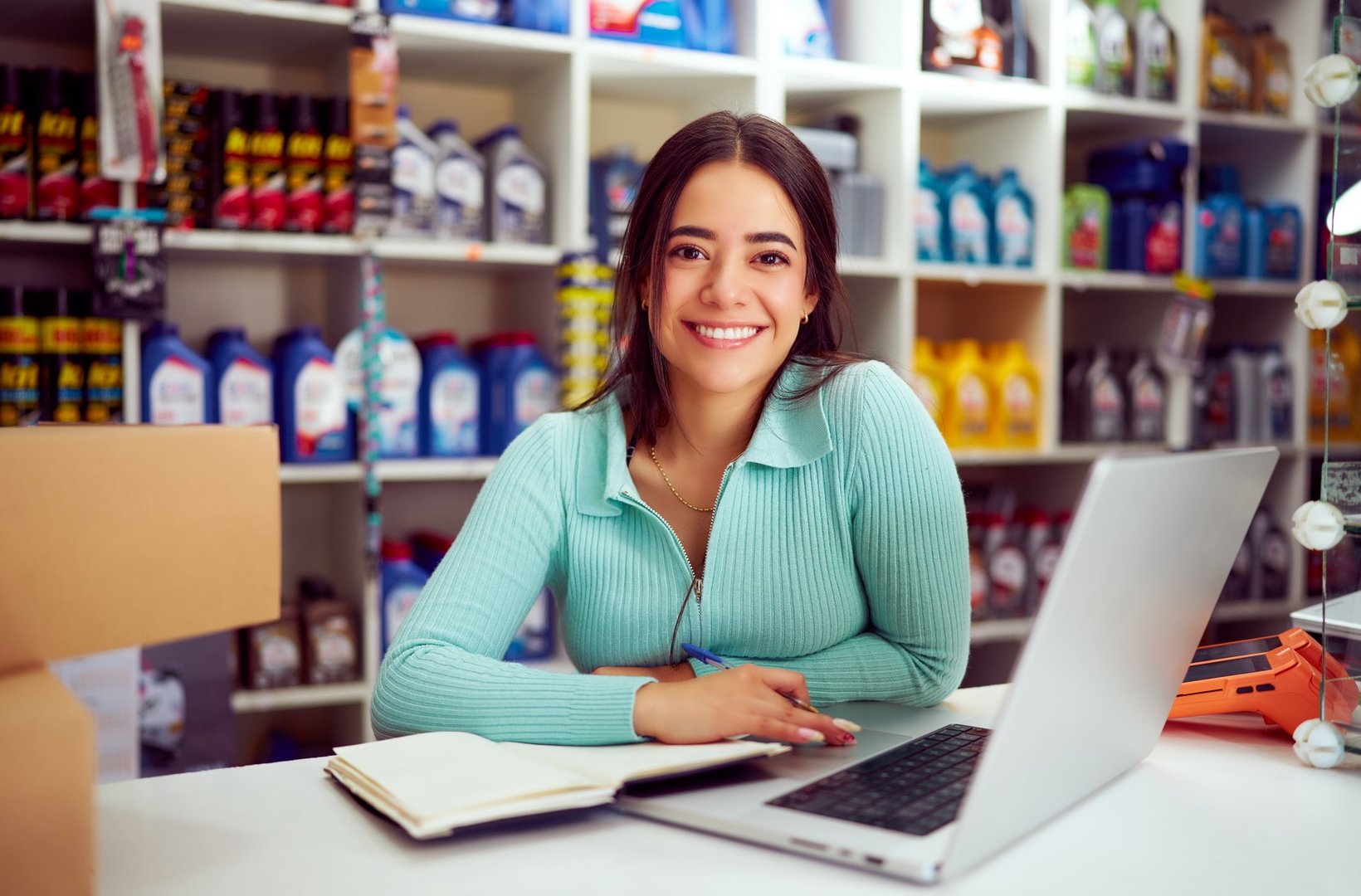 Portrait of a cheerful young entrepreneur managing her auto parts store