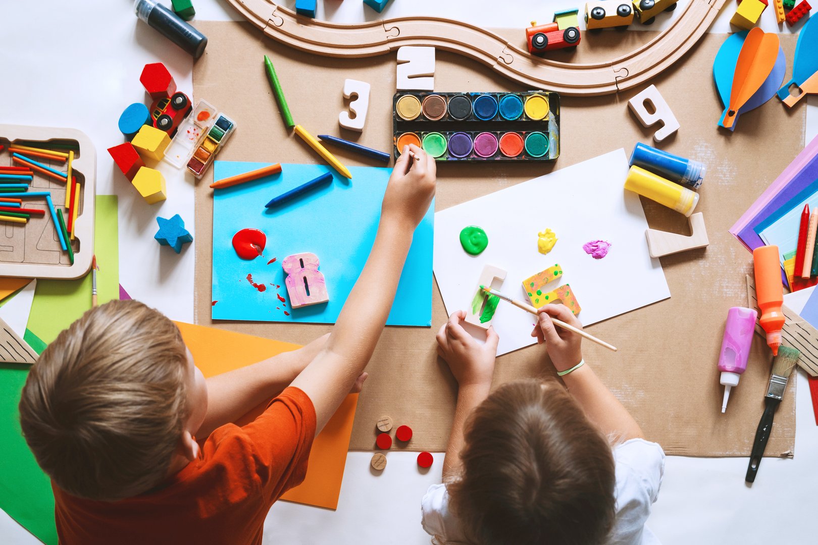 Children drawing and making crafts in kindergarten or daycare. Little kids with educational toys and supplies for creative. hildren education and development in preschool or childcare.