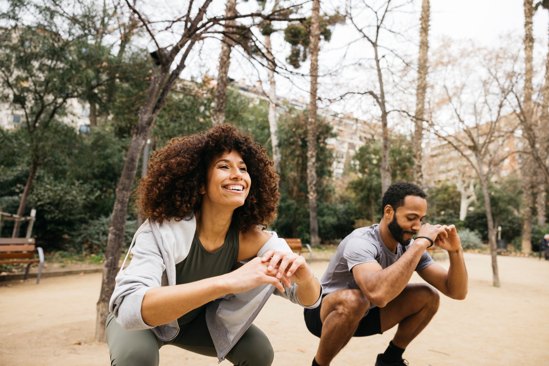 A trainer coaches a student outdoors during a fitness session, focusing on exercises and motivation.