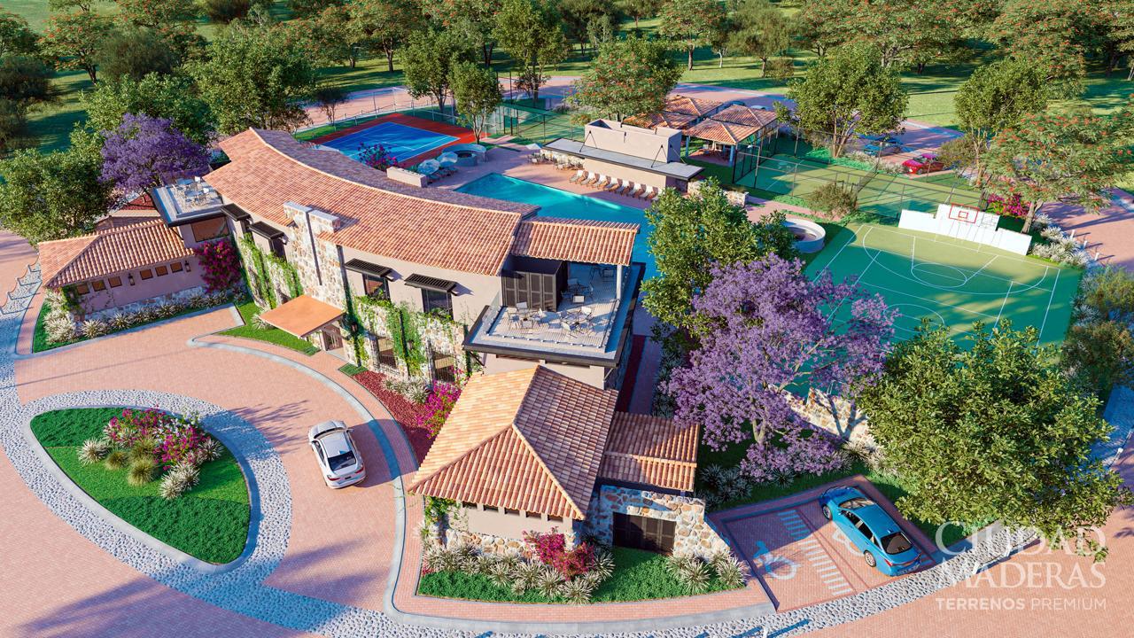 Aerial view of a luxurious clubhouse with swimming pools, tennis court, and surrounding greenery.