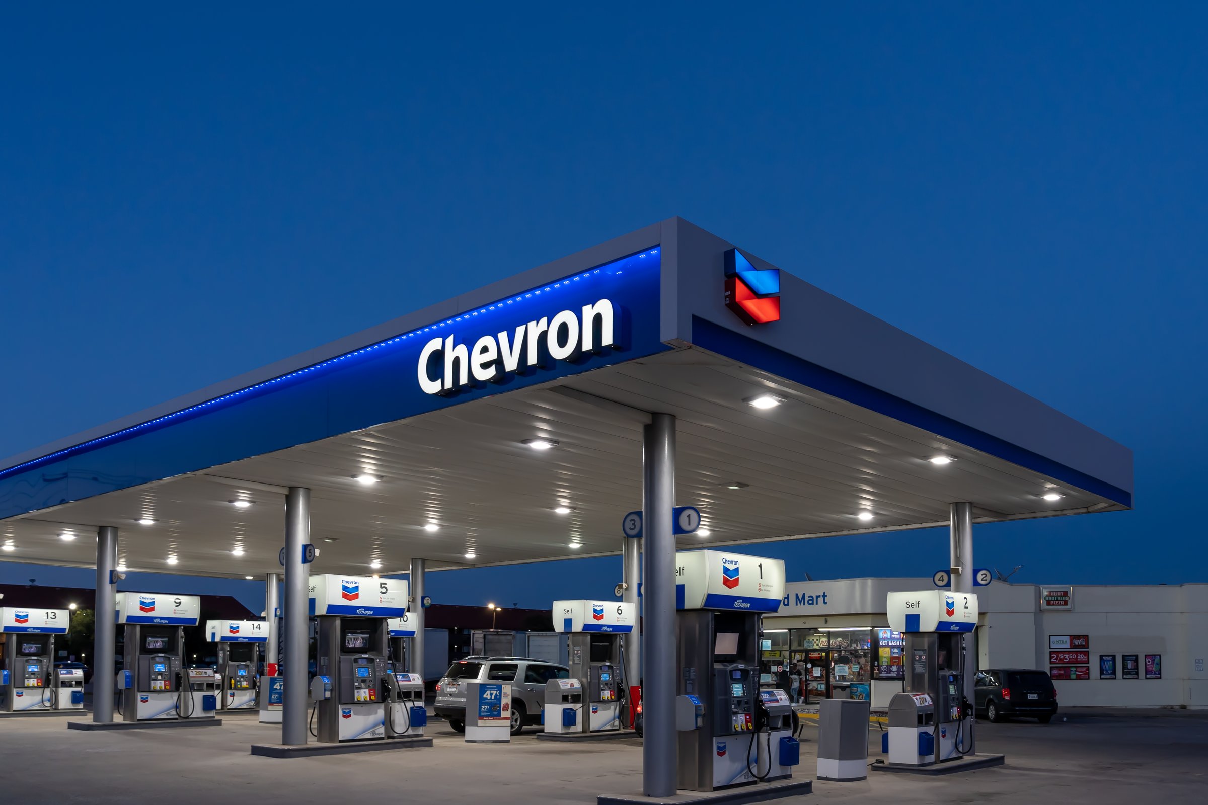 Dallas, Texas, USA - March 19, 2022: Night view of Chevron gas station sign. Chevron Corporation is an American multinational energy corporation.