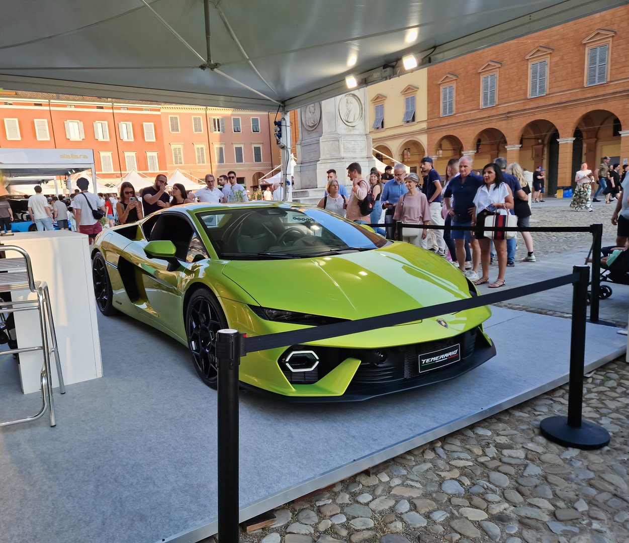 Modena italy, Naples 7 june 2025: Green lamborghini temerario terzo millennio showcased on a platform, attracting visitors at an outdoor automotive exhibition