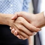 Two people shaking hands, one wearing a blue checkered shirt, symbolizing agreement or partnership.