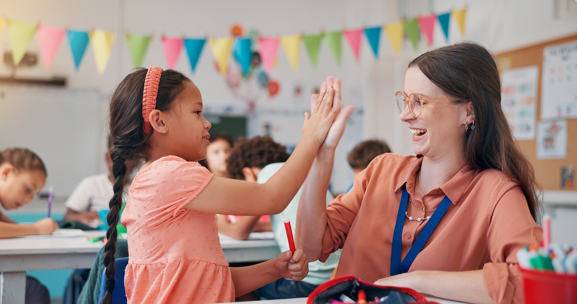 Education, girl and teacher in classroom, high five and support with child development. Knowledge, woman, and kids in school, hand gesture and results for test, growth and collaboration with top mark