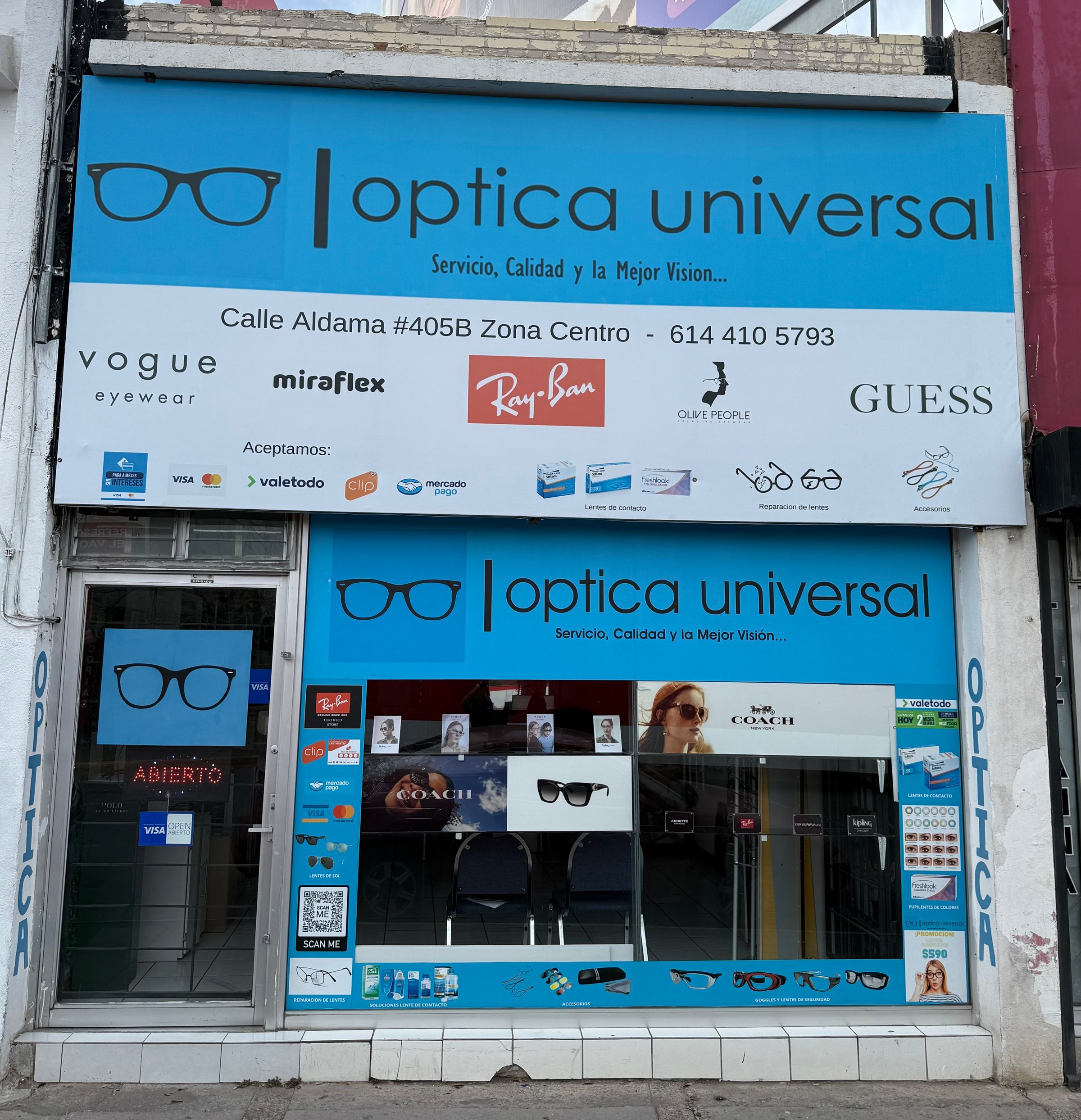 Storefront of Optica Universal featuring eyewear brands and services with blue signage and various payment icons displayed.