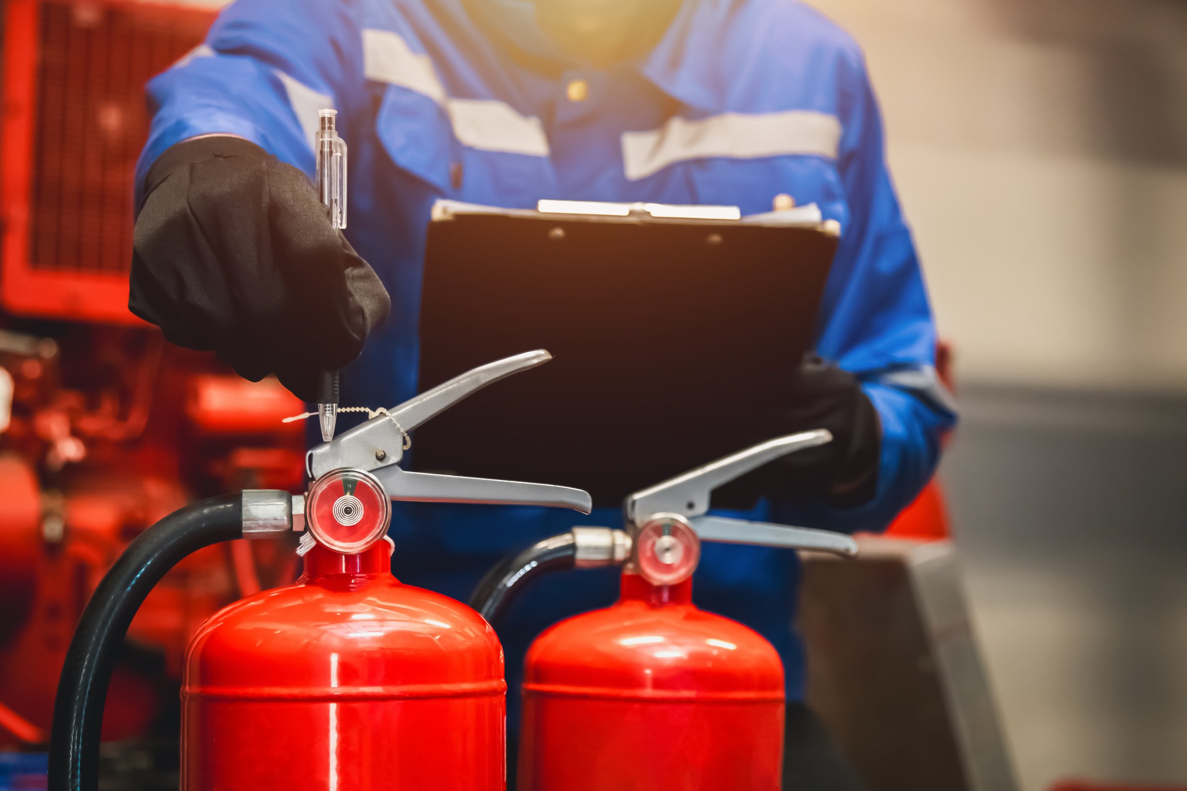 Engineer check fire extinguisher tank in the fire control room for safety in factory or industry.