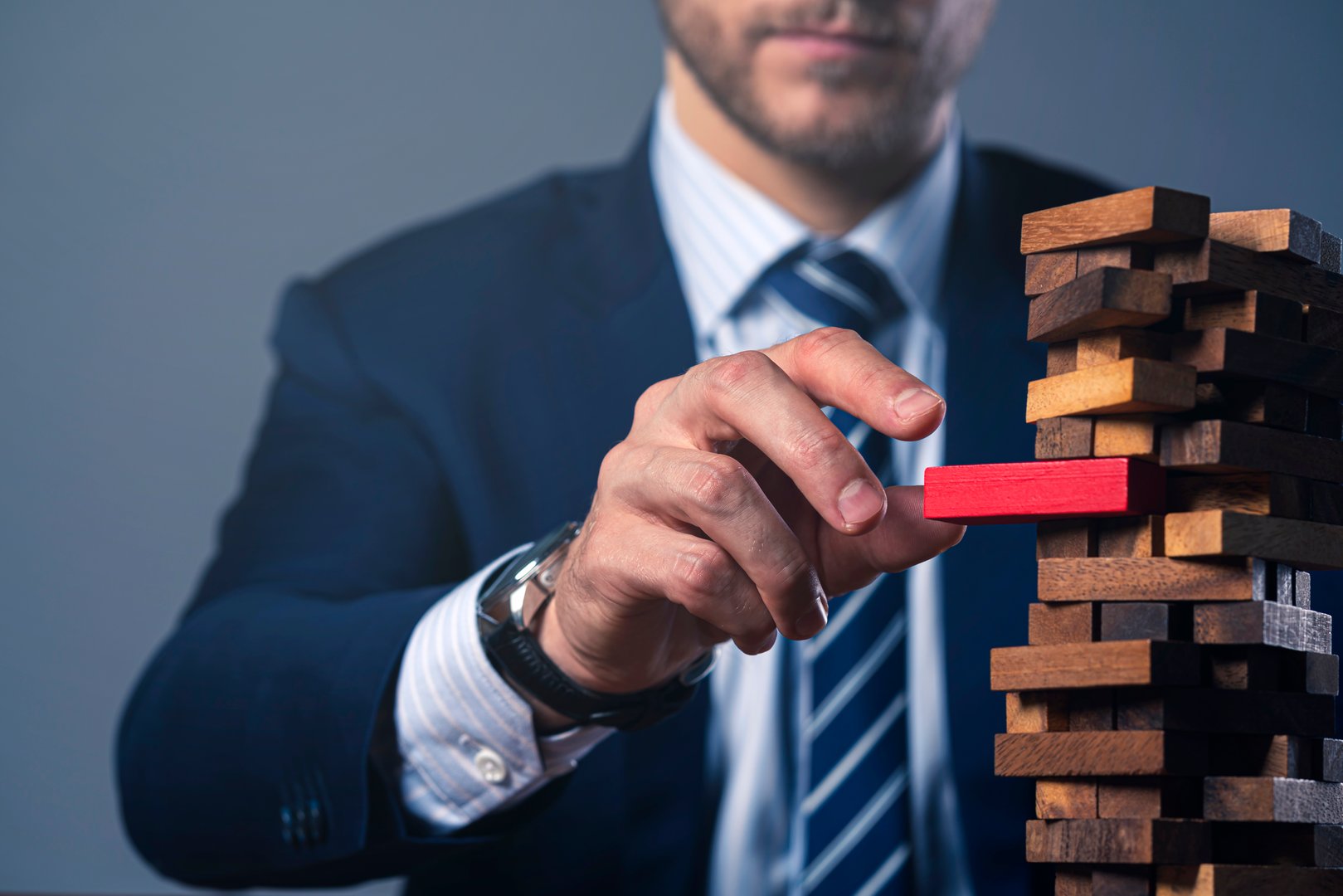 caucasian businessman suit hand hold wooden tower stack block organize and strategy ideas concept