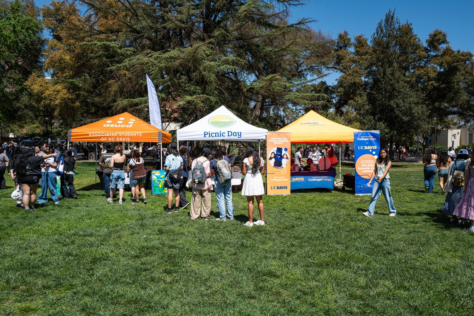 Davis, CA U.S.A. - April 12, 2025: Students and visitors walk in the quad near various booths during the U.C. Davis annual Picnic Day open house event.
