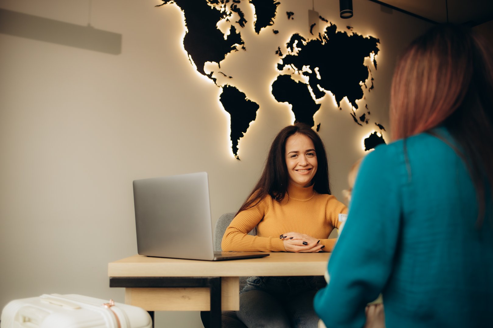 a young mother with a child chooses a vacation in a travel agency