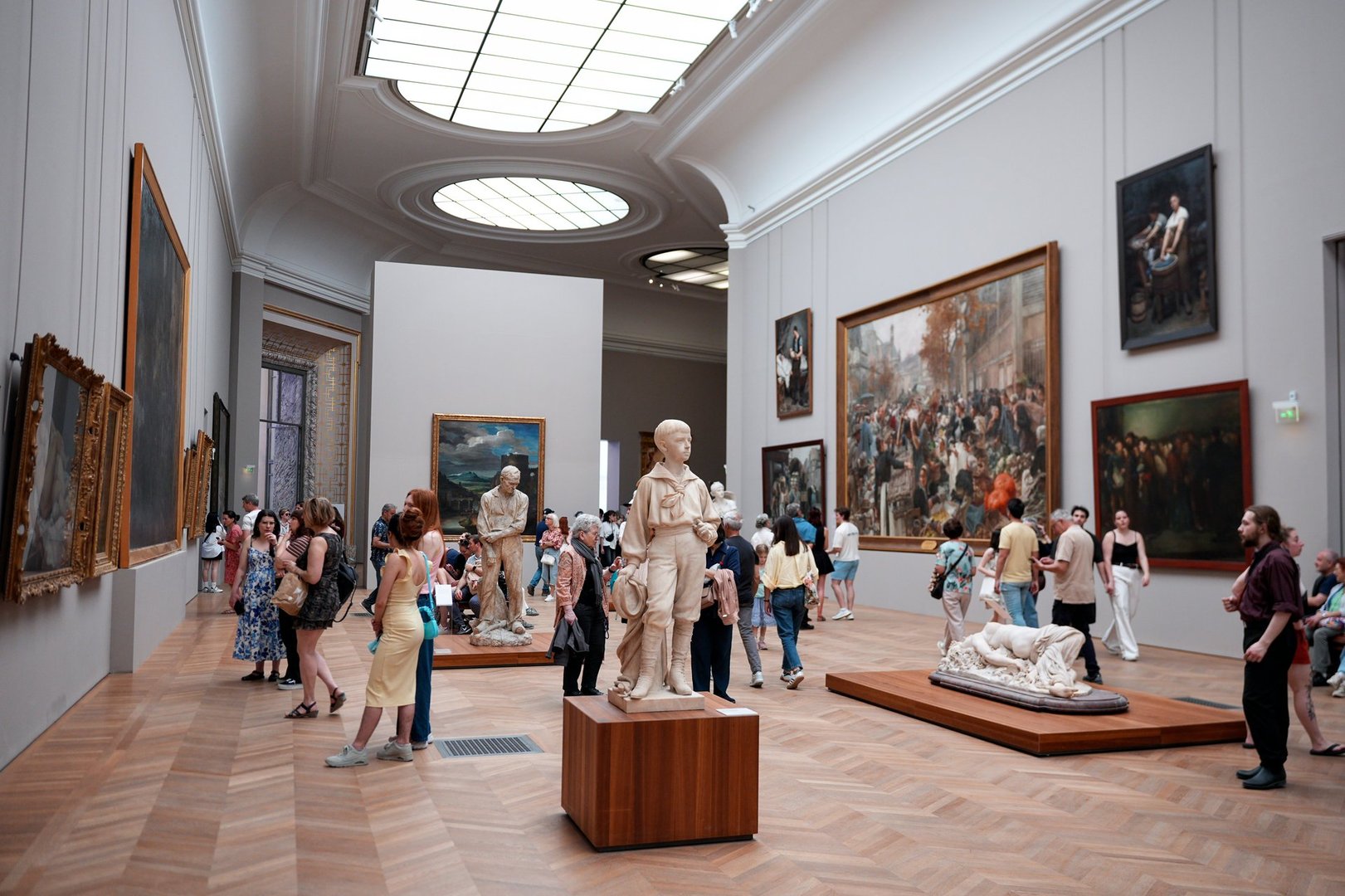 Visitors viewing sculptures and paintings inside the Louvre Museum, 30 May 2025, Paris, France