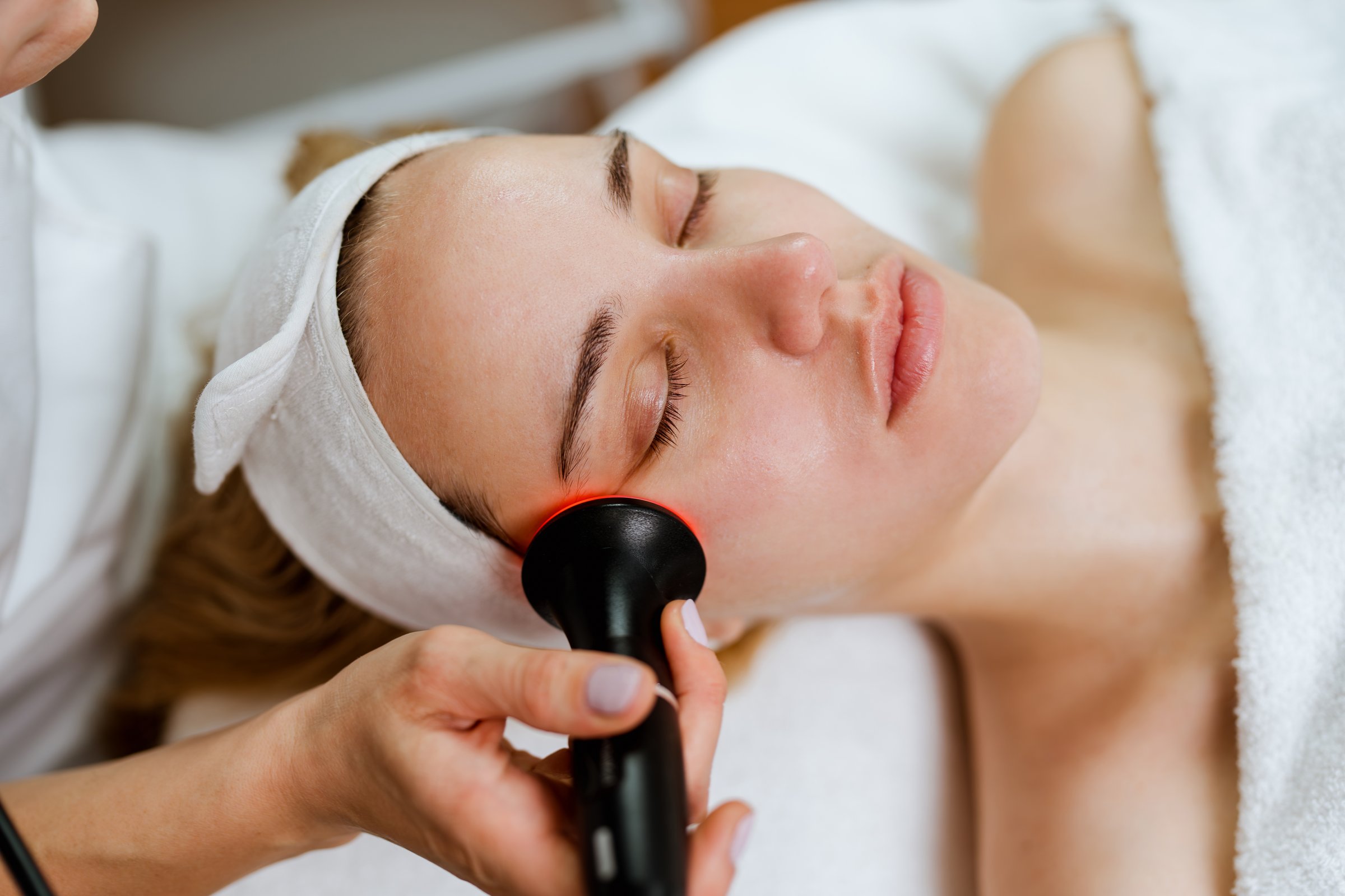 Beautician performing radio frequency lifting procedure