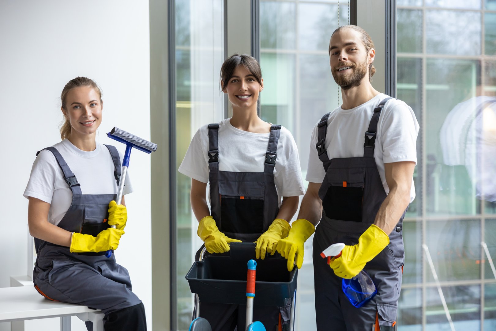Housekeeping staff. Team of housekeeping staff standing near the window in the office