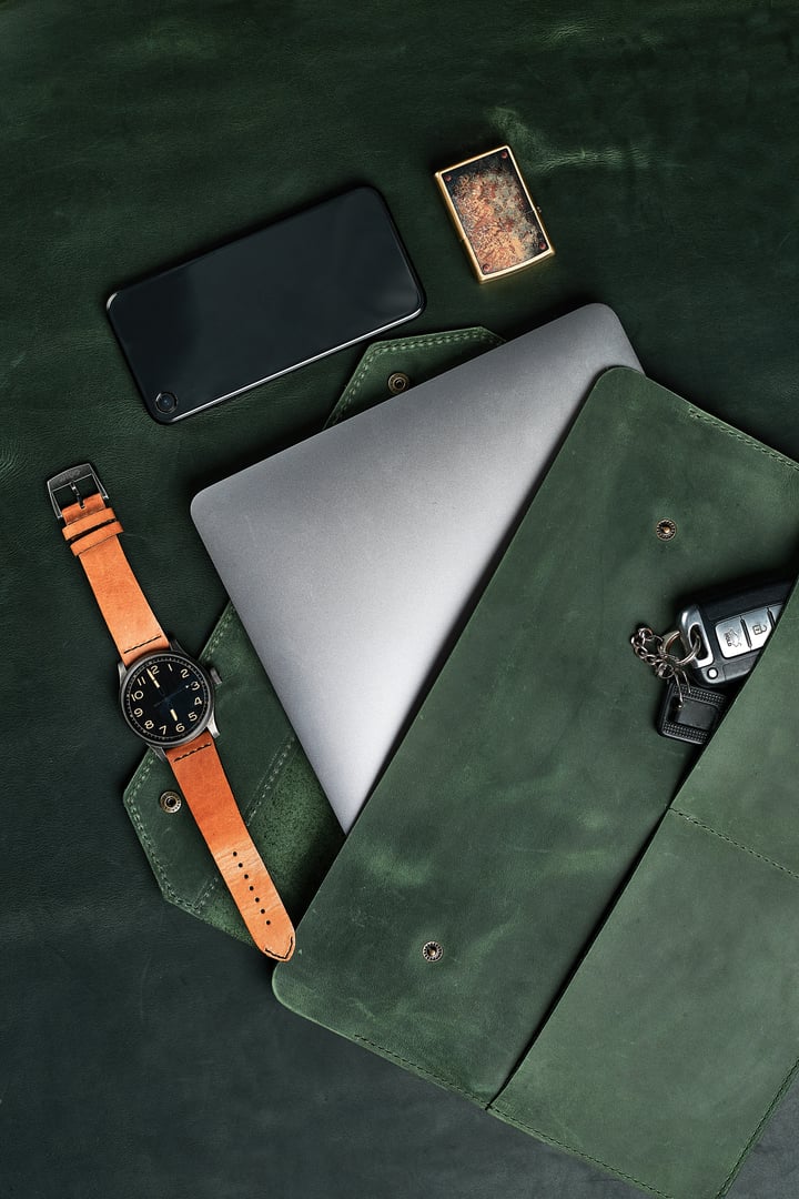 Set of handmade leather goods, key holder rings, wallet, purse, notepad, handbook. Handcrafted leather goods, close-up.