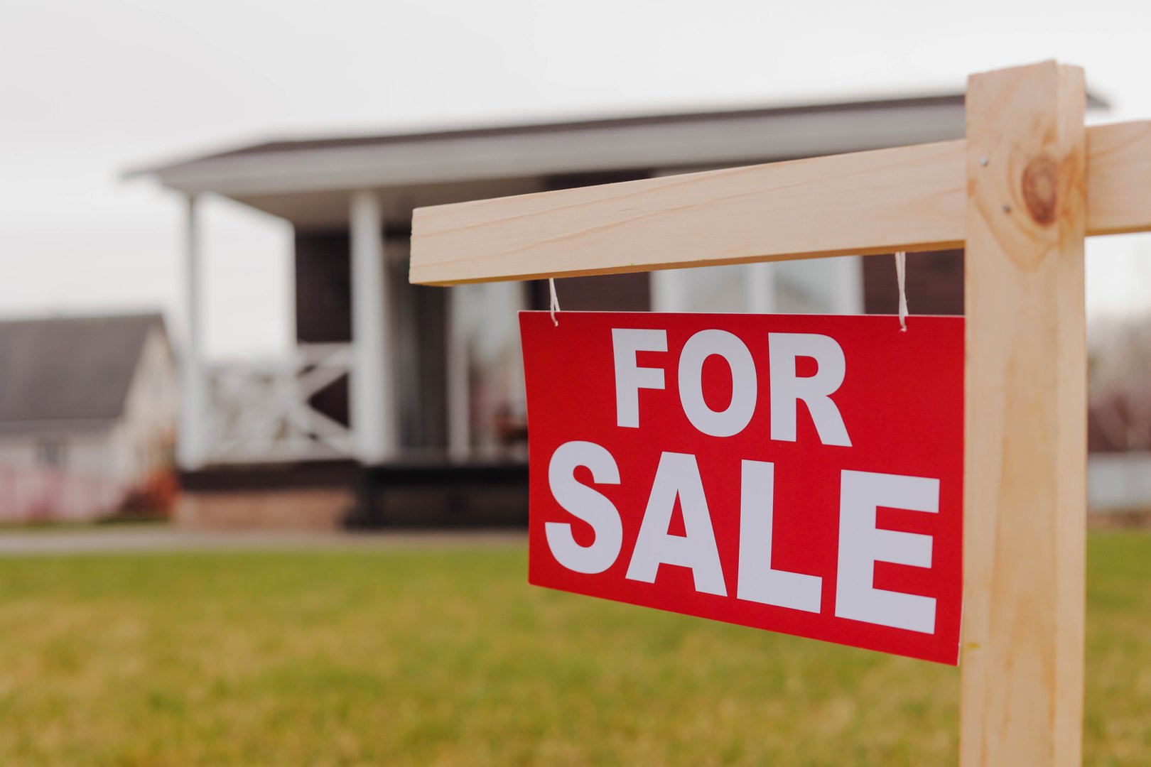 Home For Sale Real Estate Signboard in Front of New House in Slow Motion. Real Estate Market.