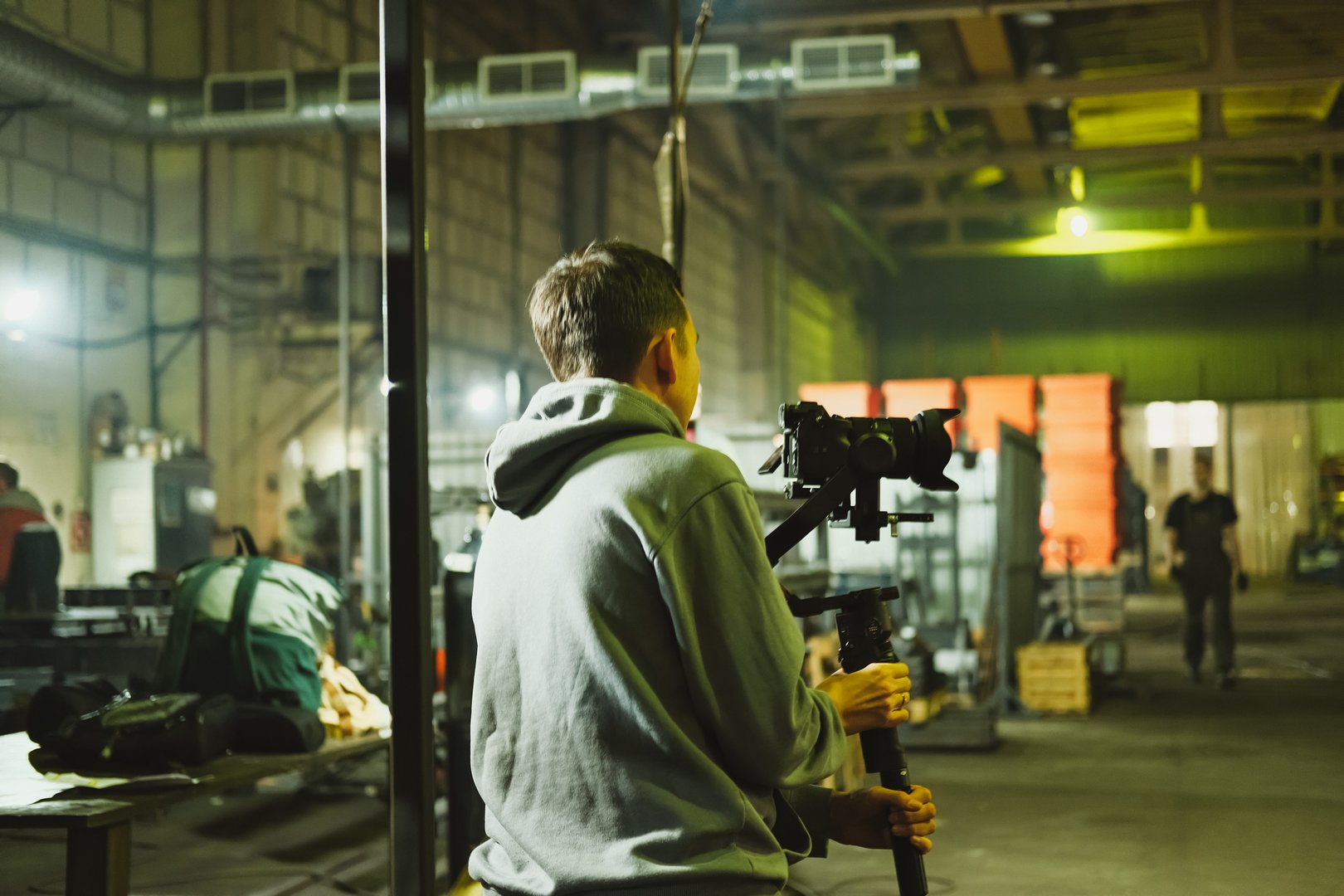Filmmaker preparing to shoot in a spacious industrial setting in Saint Petersburg, Saint Petersburg, Russia