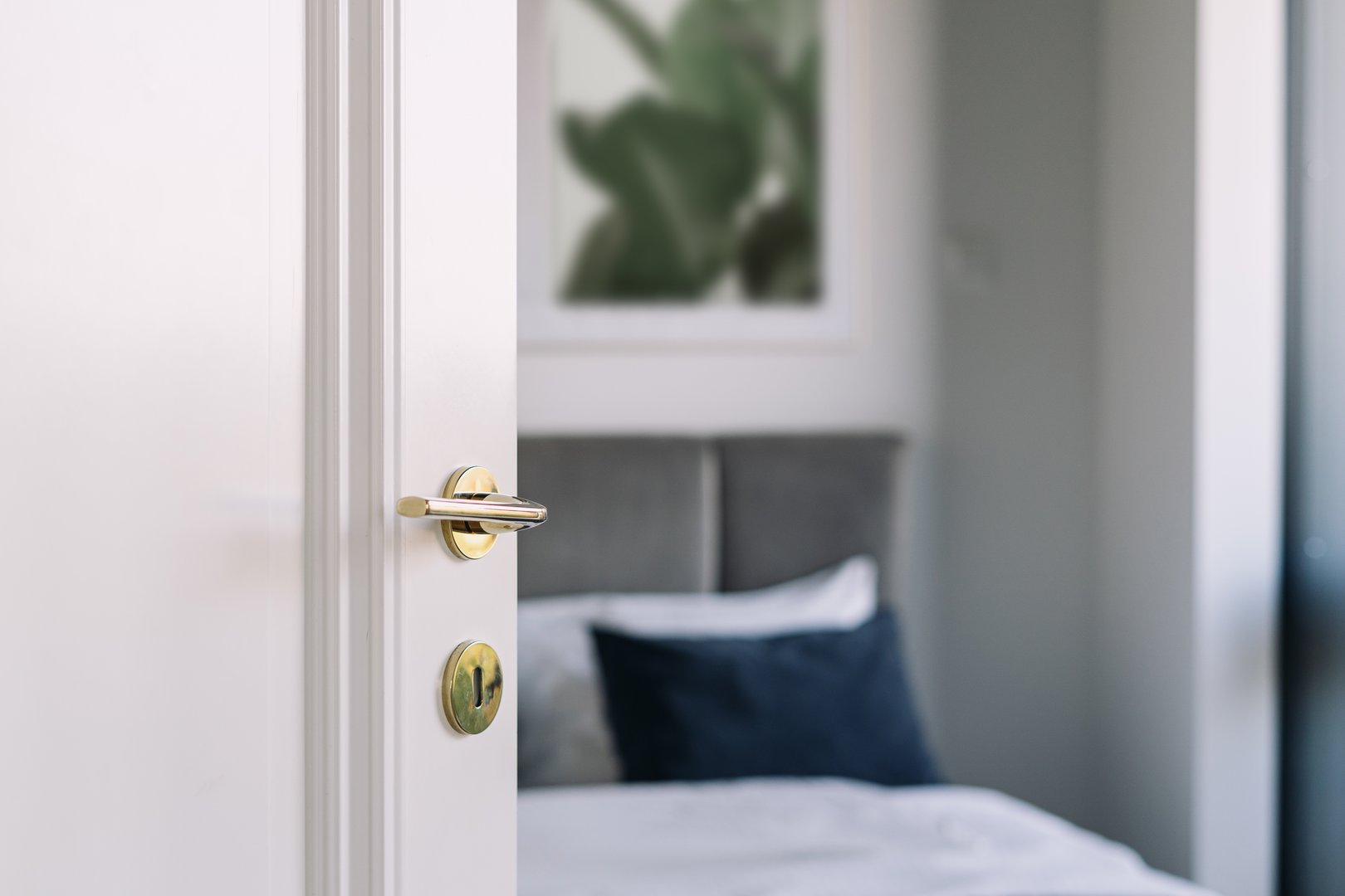 Open door in bedroom. Self check in into a hotel room. Concepts of booking apartment. A stylish suite features a comfortable bed with soft bedding, inviting guests to enjoy a tranquil morning