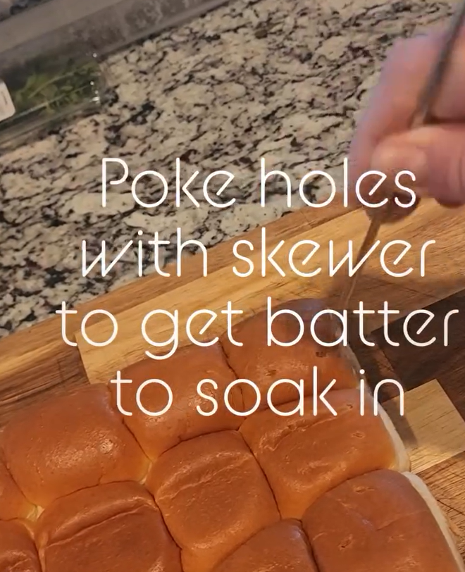 Using a skewer to poke holes in King's Hawaiian rolls for French toast