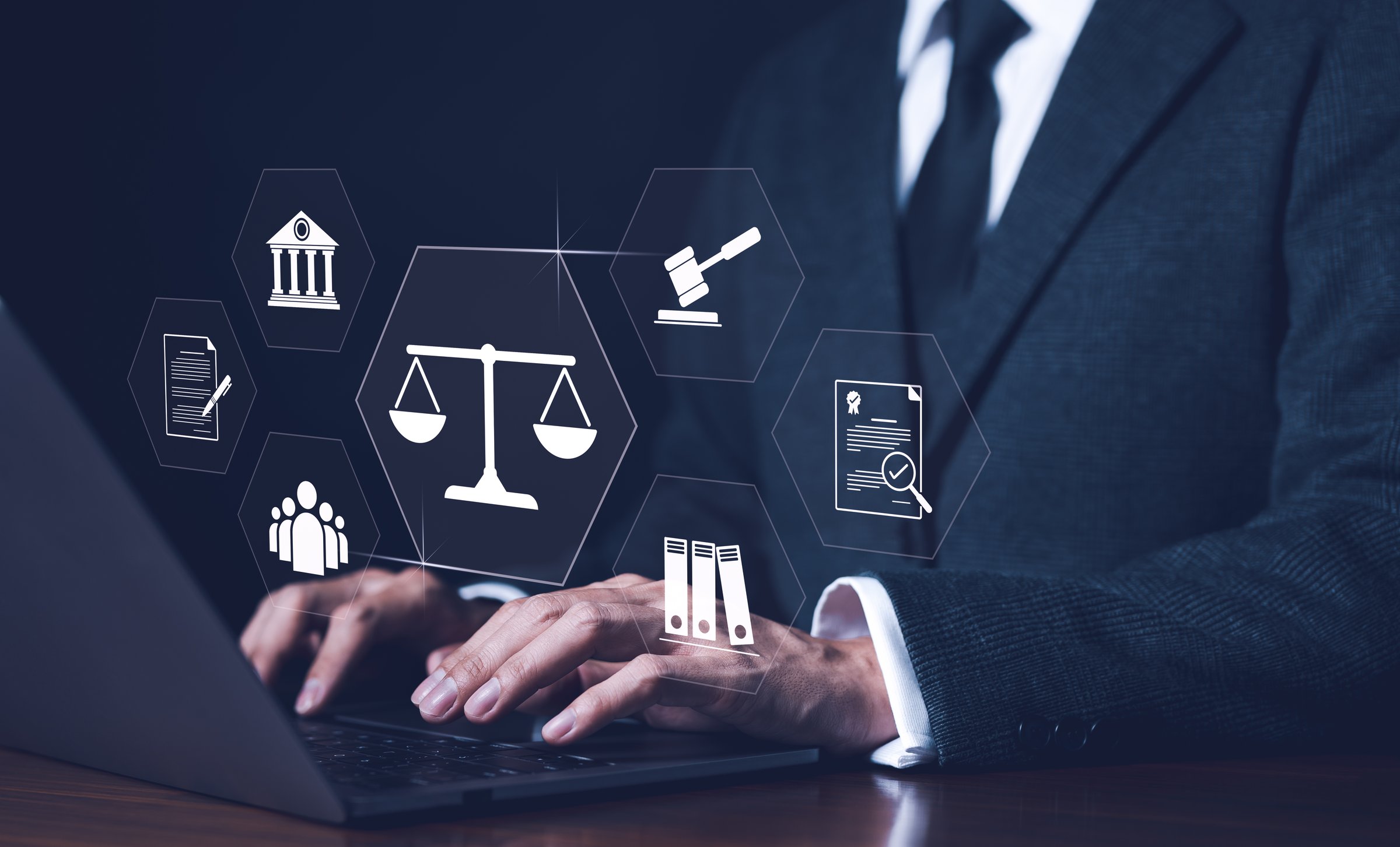 Businessman or Lawyer working with legal services icons on a laptop virtual screen can legal advice online such as labor law for business or company. Notary public, business legislation, justice,