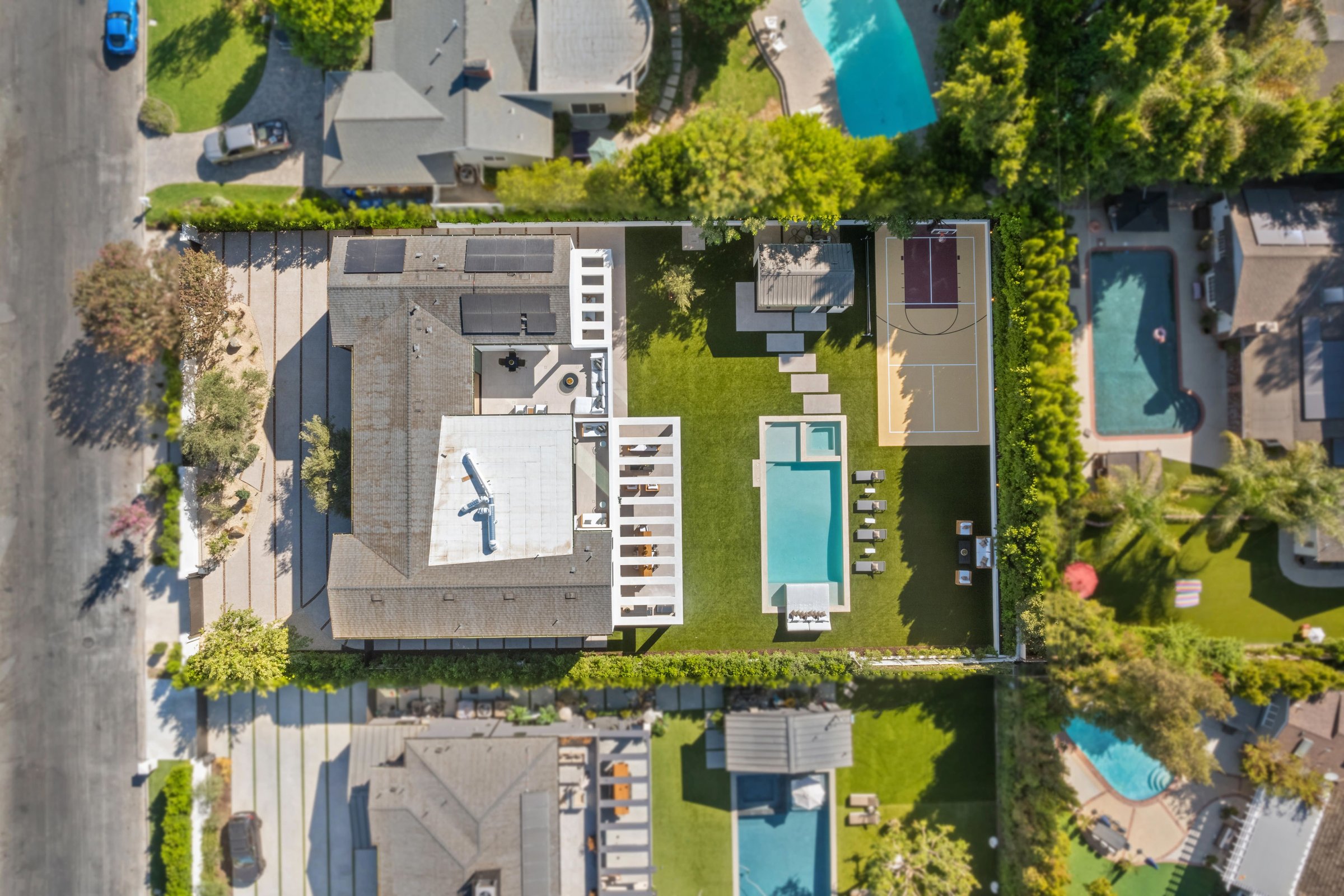 Aerial view of a luxurious residential property featuring a modern house, swimming pool