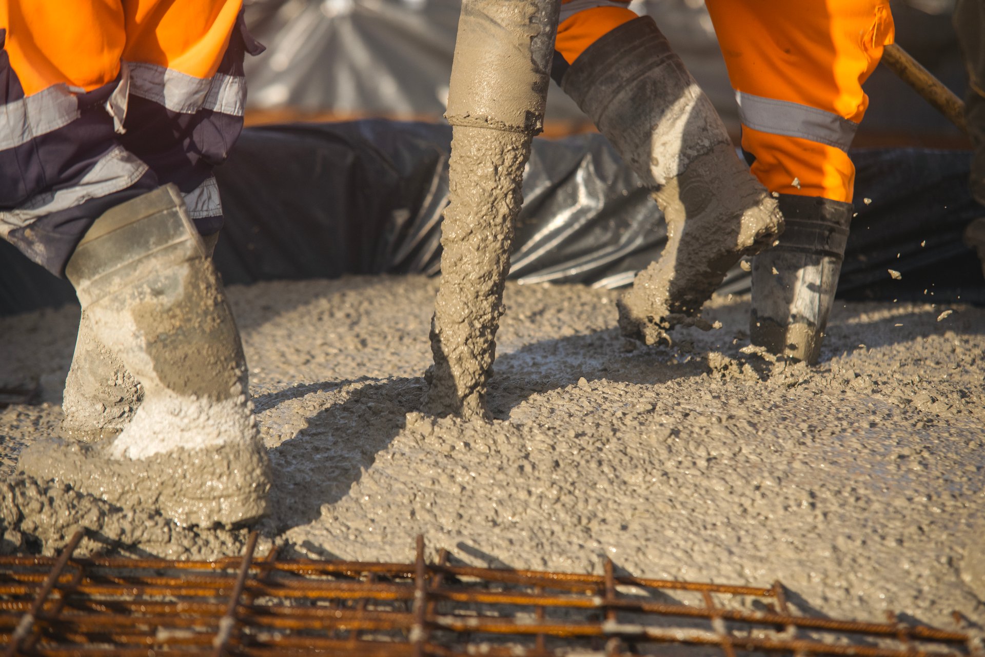Close-up of Builders pouring floor slab from concrete pump