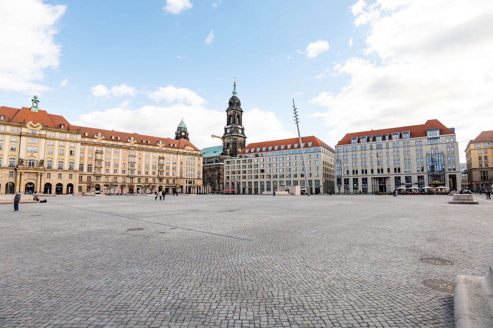Dresden Altmarkt (old market) square in the historic old town. Paved square and facades of the buildings in the inner city. Towers of the Kreuzkirche and the city hall.