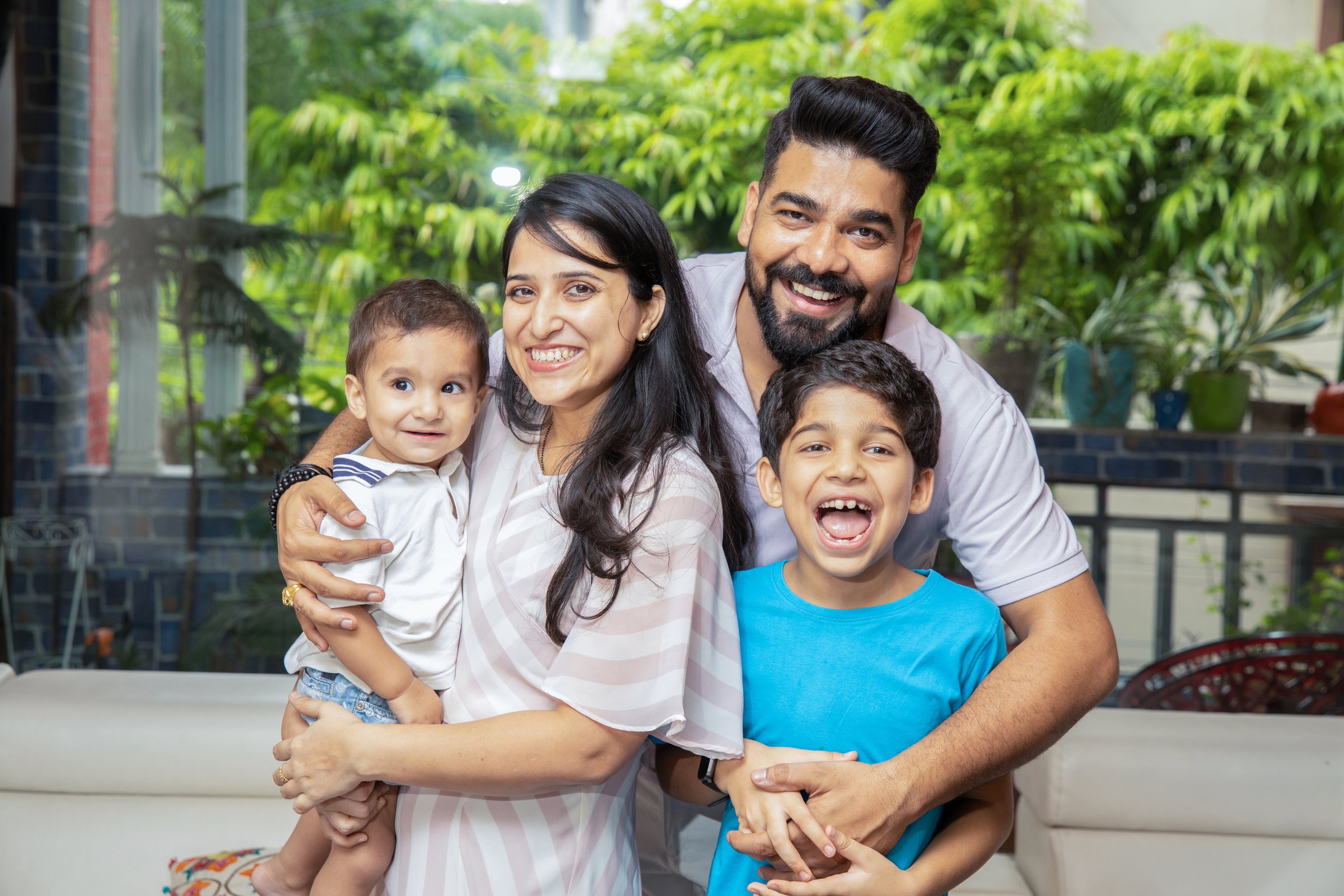 Cheerful Young Indian Family Of Four Having Fun Together At Home
