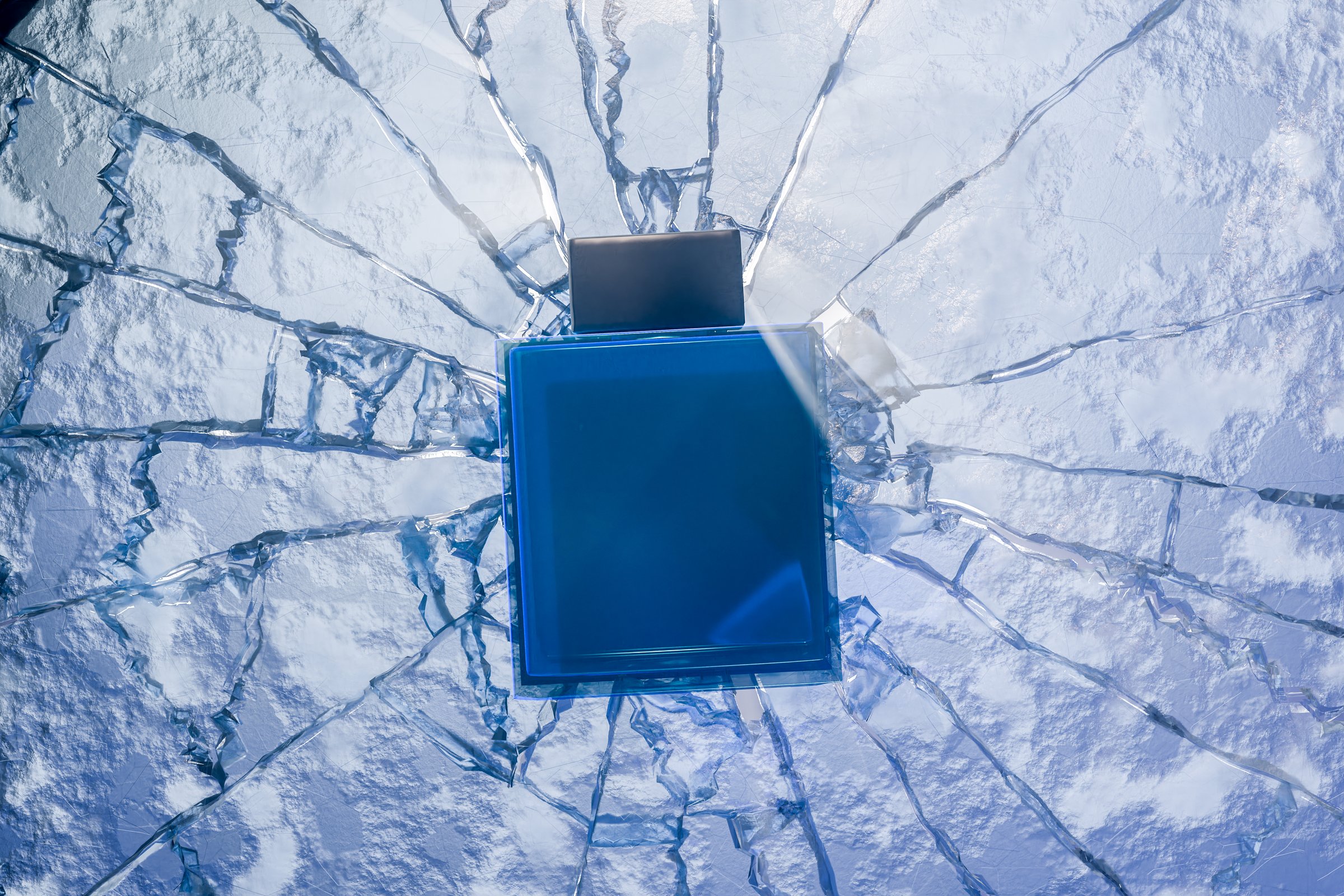 Blue men perfume bottle on cracked glass surface, elegant fragrance mockup, luxury cologne packaging, shattered ice background, stylish scent container, aroma presentation, modern design