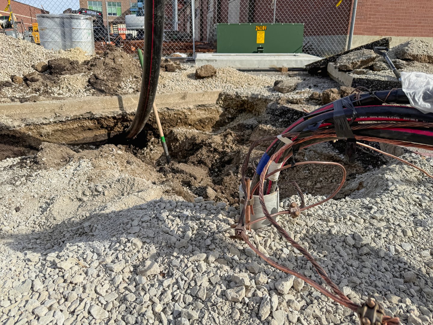 Springfield, Illinois, USA : October 24, 2025 Large hole has been excavated for industrial wiring for a new electrical box. Located at a large new building construction site.